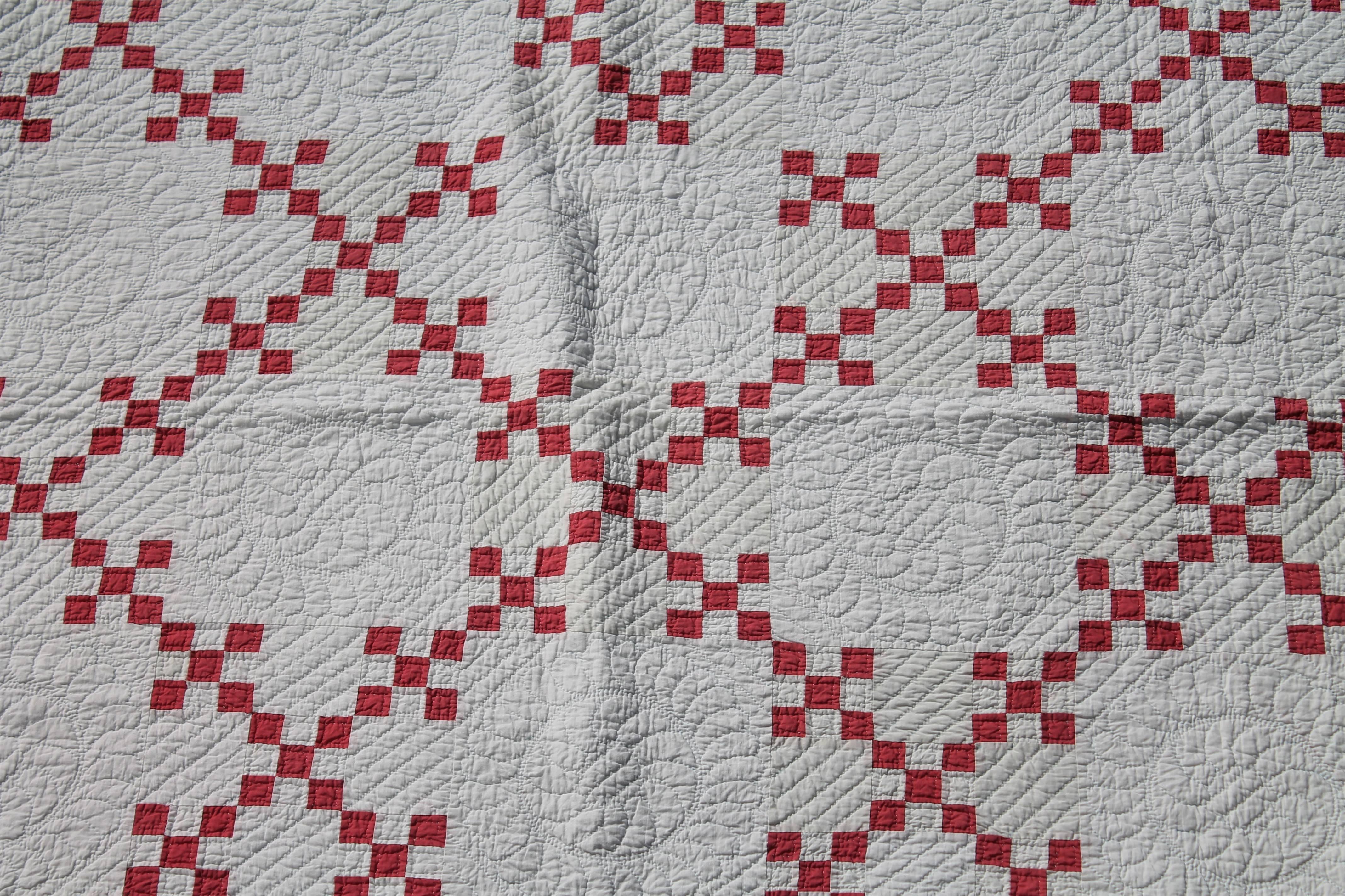 This interesting soft red Irish chain quilt is in pristine condition. This quilt has wonderful quilting and nice piecing.