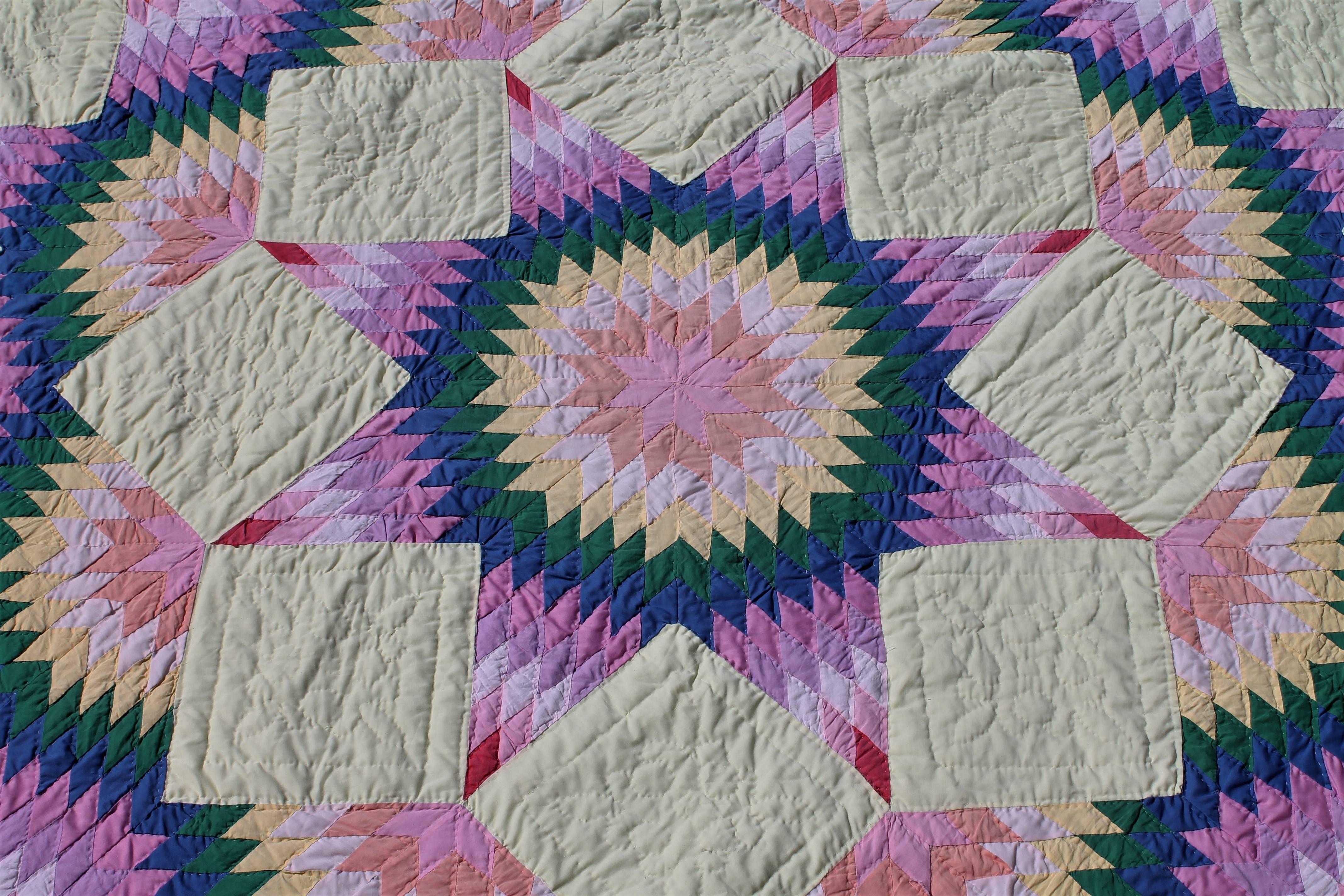 This pastel broken star quilt is in fine condition and is all hand pieced and quilted. The condition is very good.