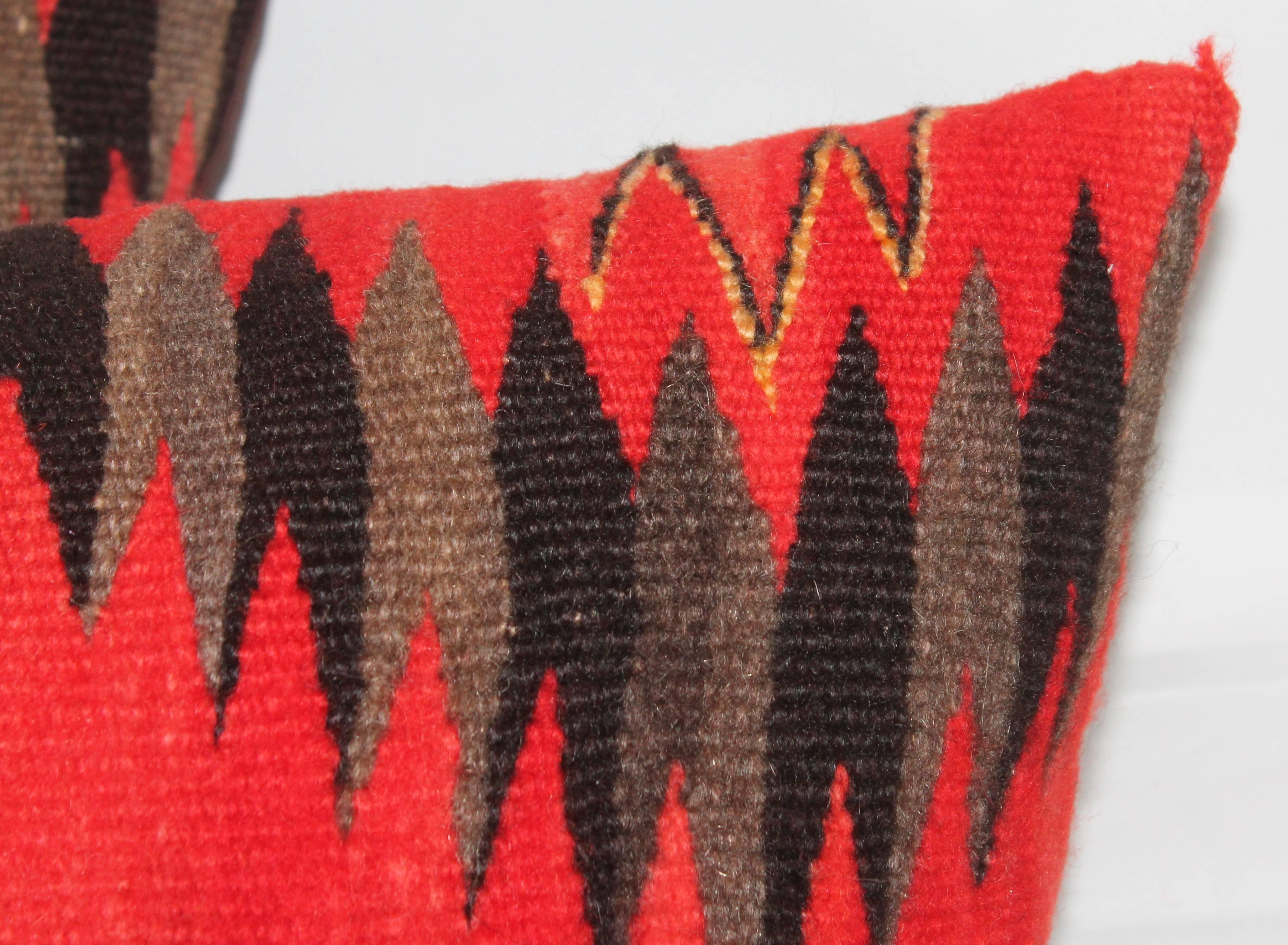 These very vibrant Navajo Indian weaving pillows are in fine condition. The backing is in a brown cotton linen. Down and feather fill.