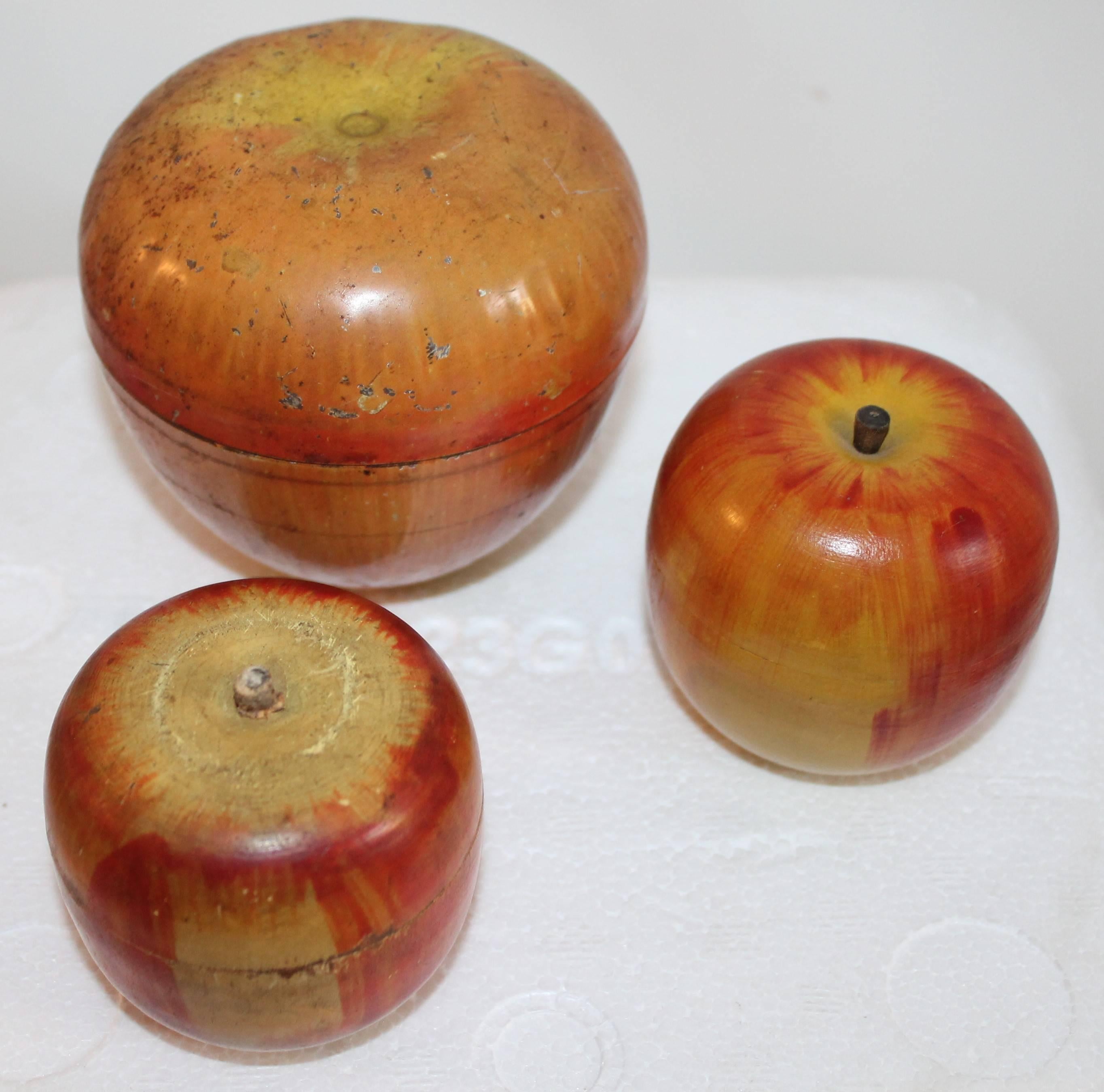 The large tin painted apple is signed Wyandotte Toys is on the large tin candy container, the large tin apple is 4.5