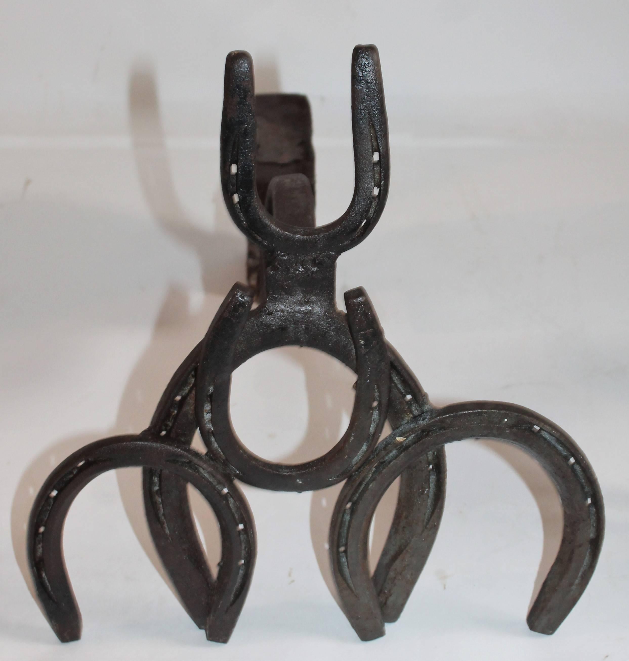 These folky handmade horse shoe andirons are in good condition and are very sturdy and heavy. Wonderful western Folk Art.