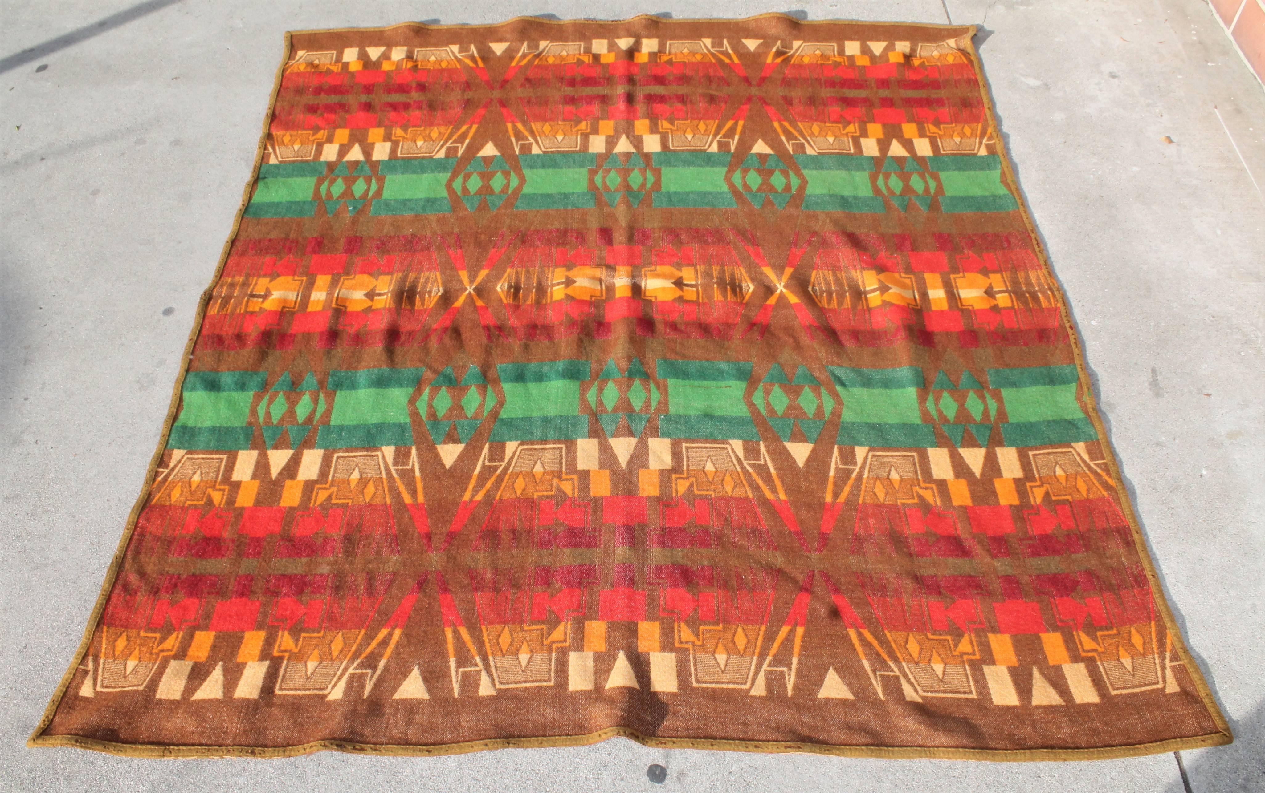 This very early Cayuse / Pendleton wool blanket is in nice condition with a minor repair around the original black label. The colors are soft  like a Indian sunset. It is dated 1919 on the label.