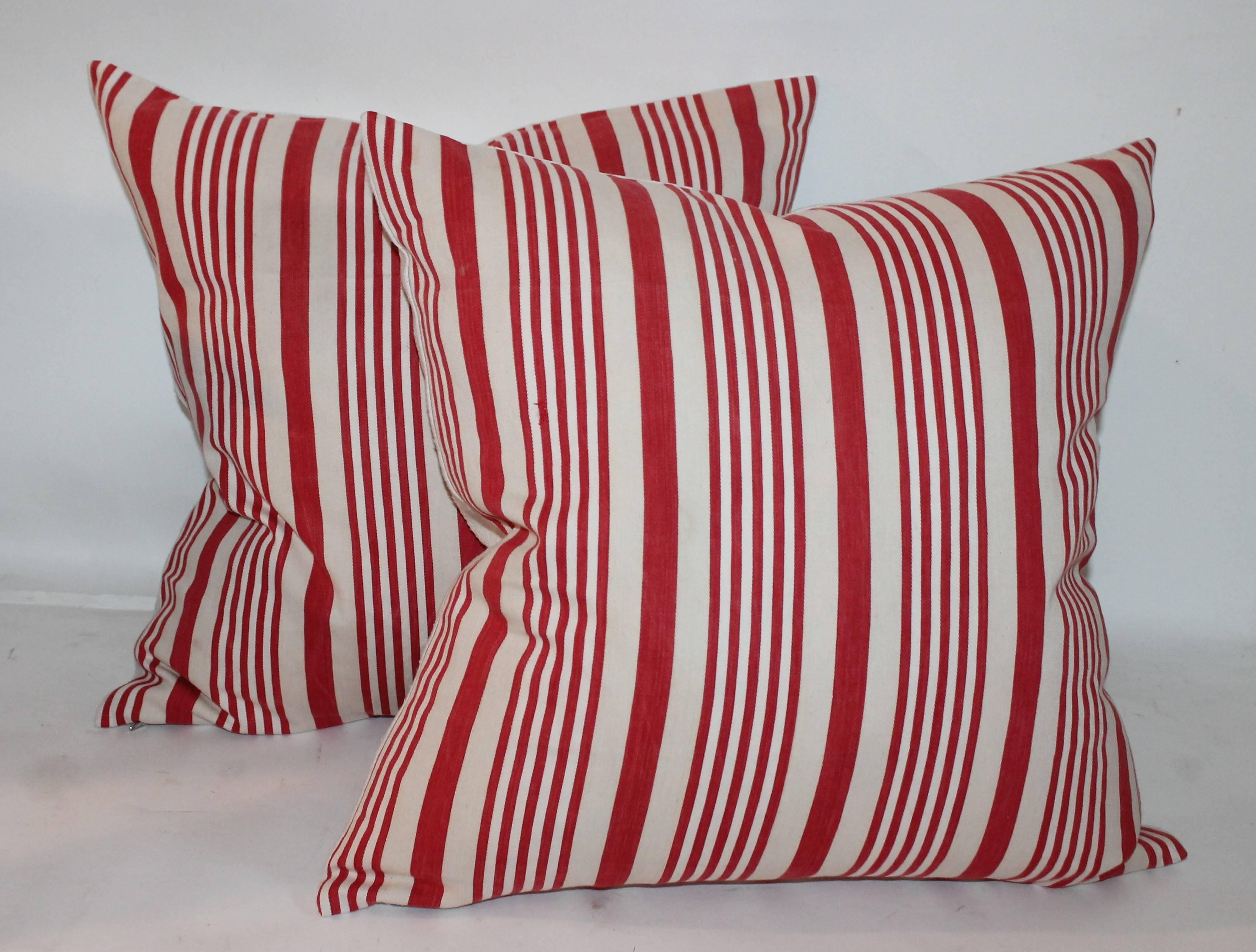 These amazing early red and white striped ticking pillows are in great condition and are sold in pairs. There are two pairs in stock a 20 x 20 and a pair 22 x 22. Sold individually.