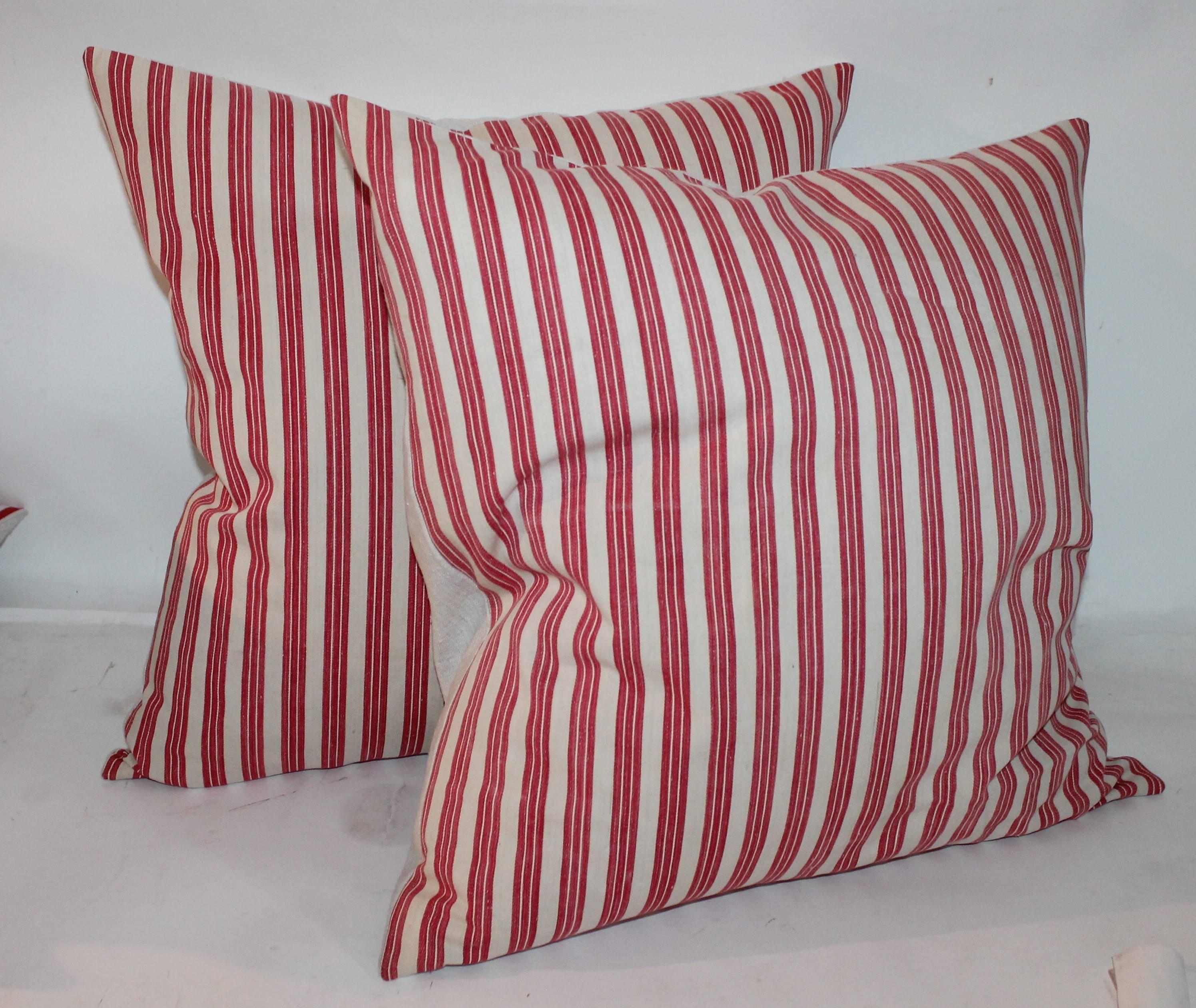 These red and white stripe ticking pillows are in fine condition. They come in sizes 20 x 20 and in 22 x 22. Four pairs in stock.