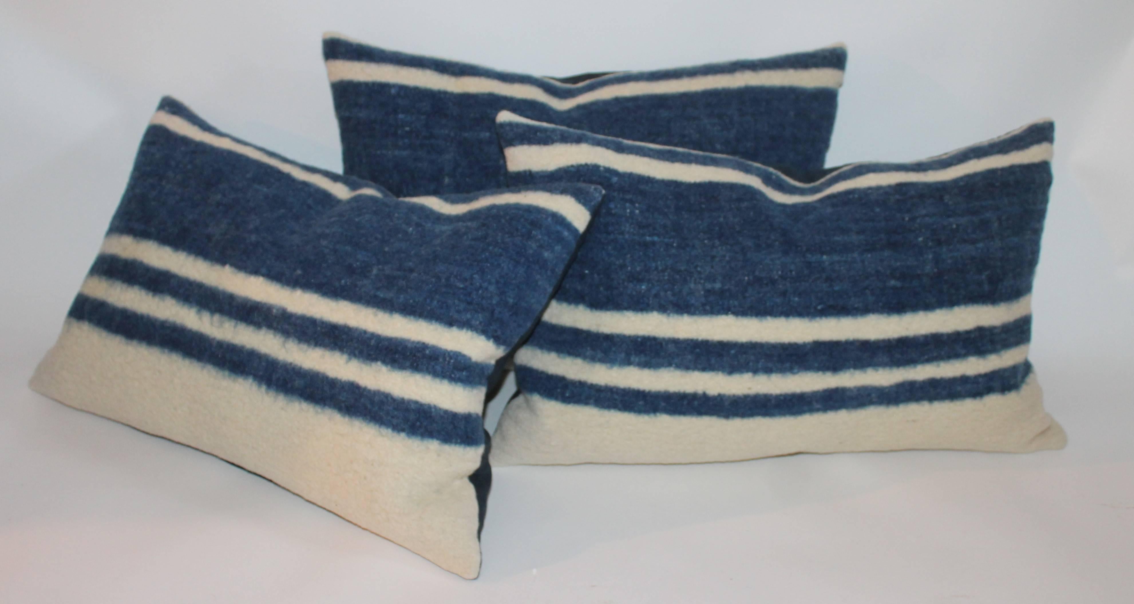 Collection of three Alpaca Indian weaving striped pillows in fine condition. The backing is in blue cotton linen.