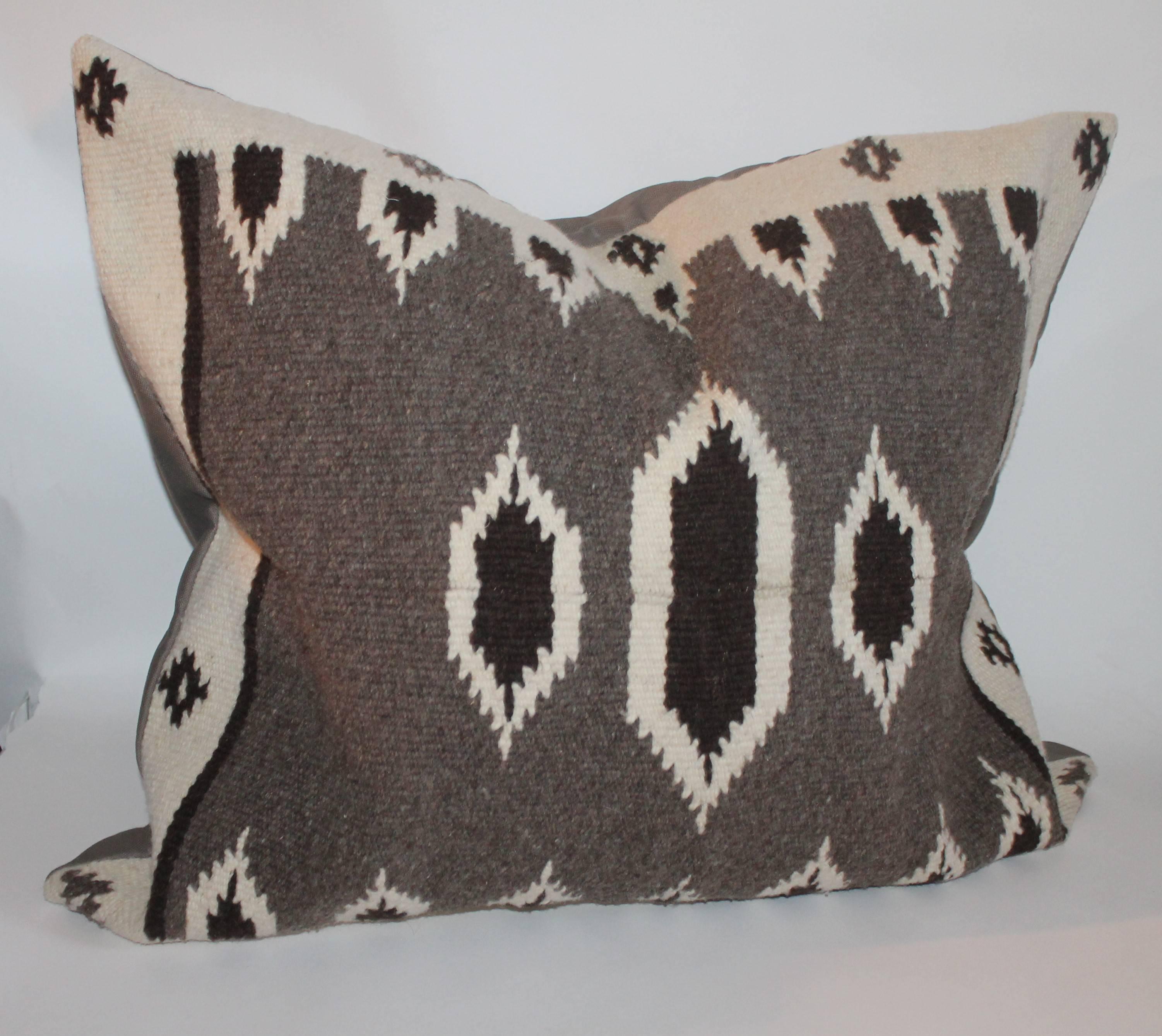 This handwoven Indian weaving pillow is in fine condition and large in size. The backing is in a dark brown linen.