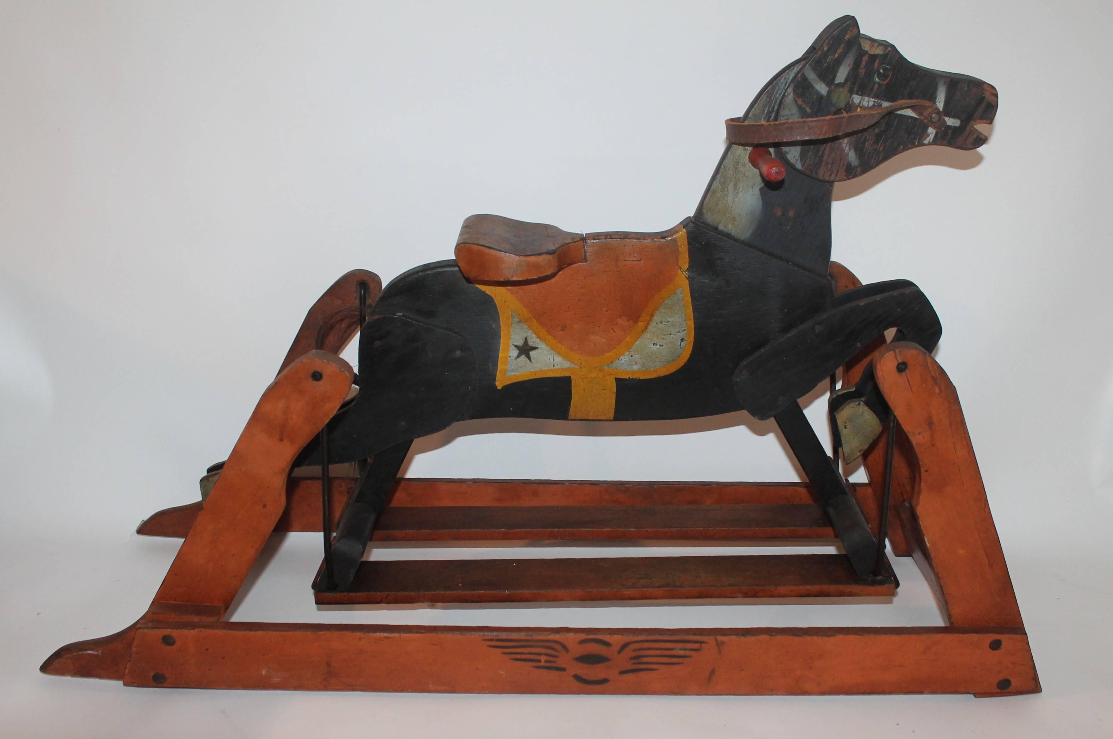 This painted salmon and black original painted rocking or platform horse has the very best painted surface. Great for table top or on cupboard. Super patina.