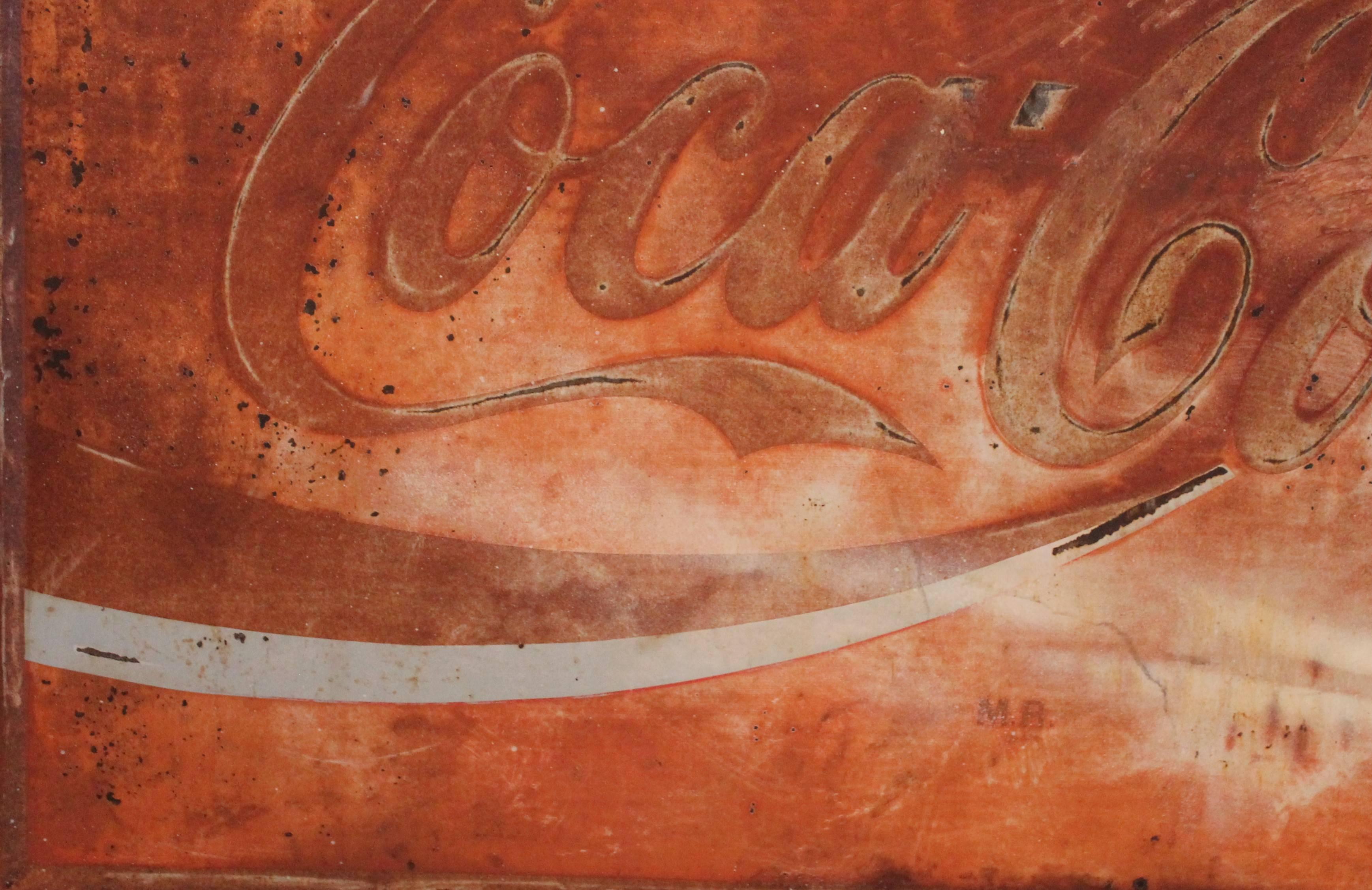 Early coca cola original painted tin sign with a worn and aged surface. This sign has four holes as to wear to hang it. Looks like salmon painted surface.