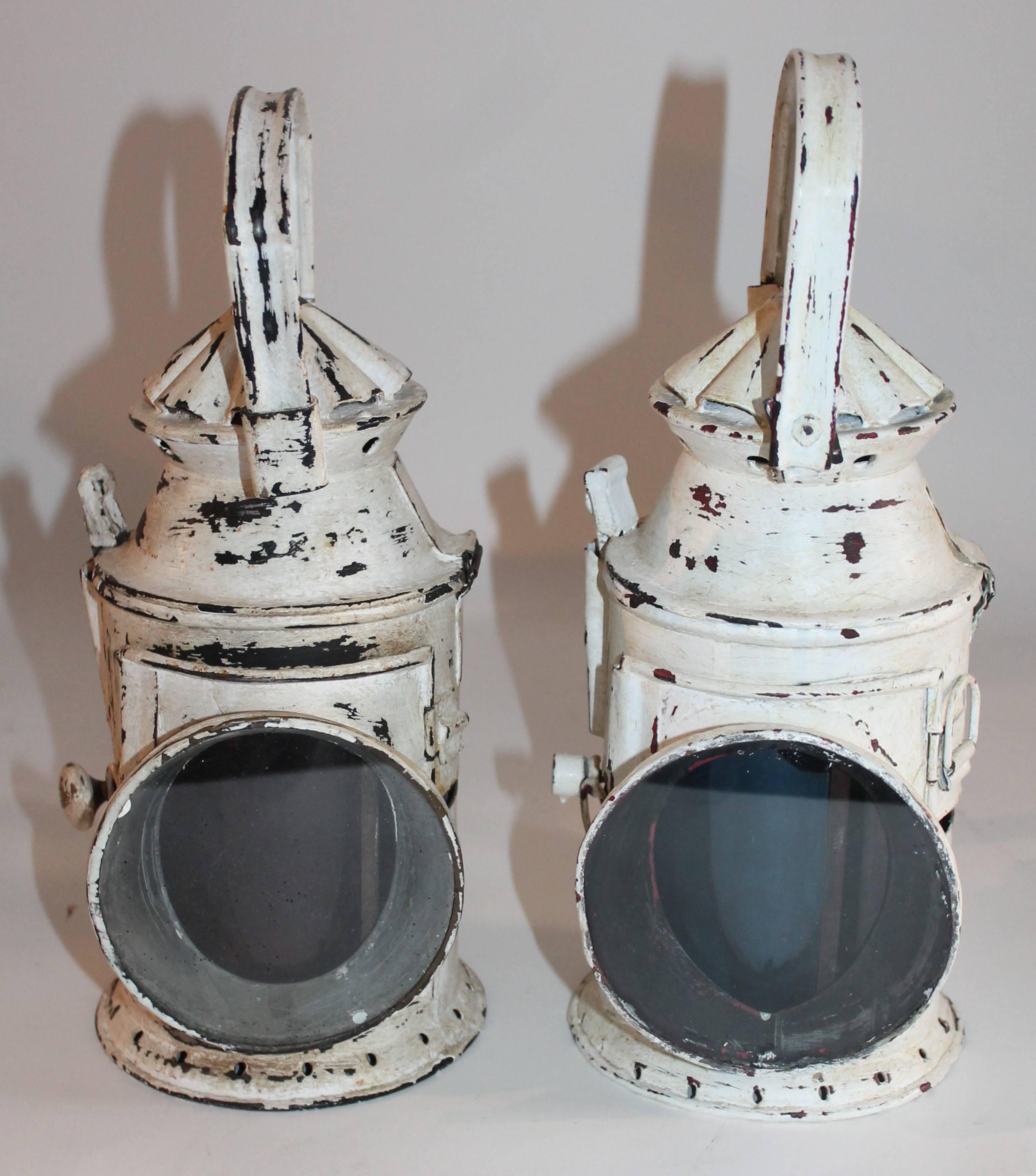 19th century white over black painted coal miners lanterns with all original glass interiors. Sold as a pair.