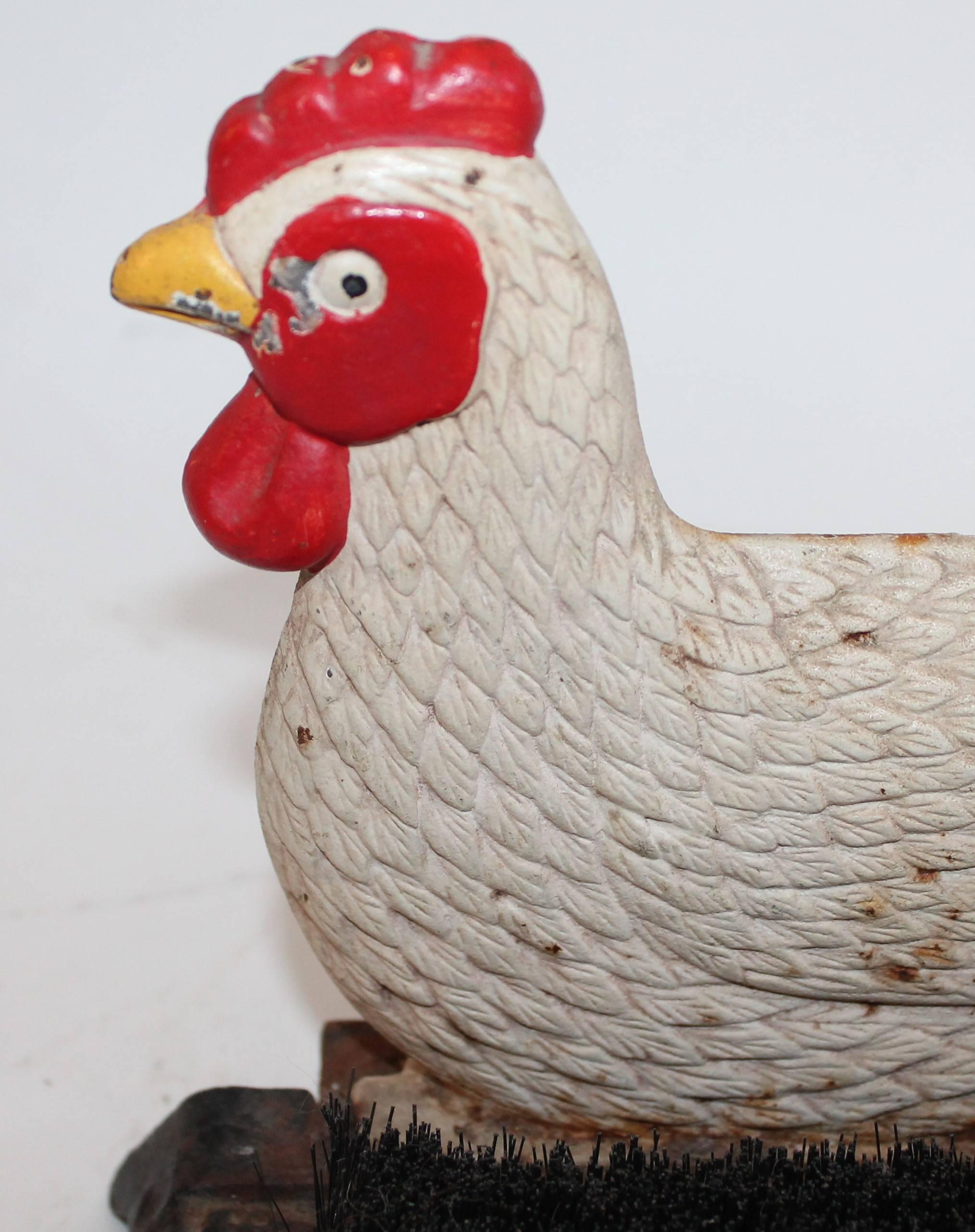 This original painted rooster boot scraper is good condition. This boot scraper has the original brush inside of it. The condition is very good and has nice original surface.