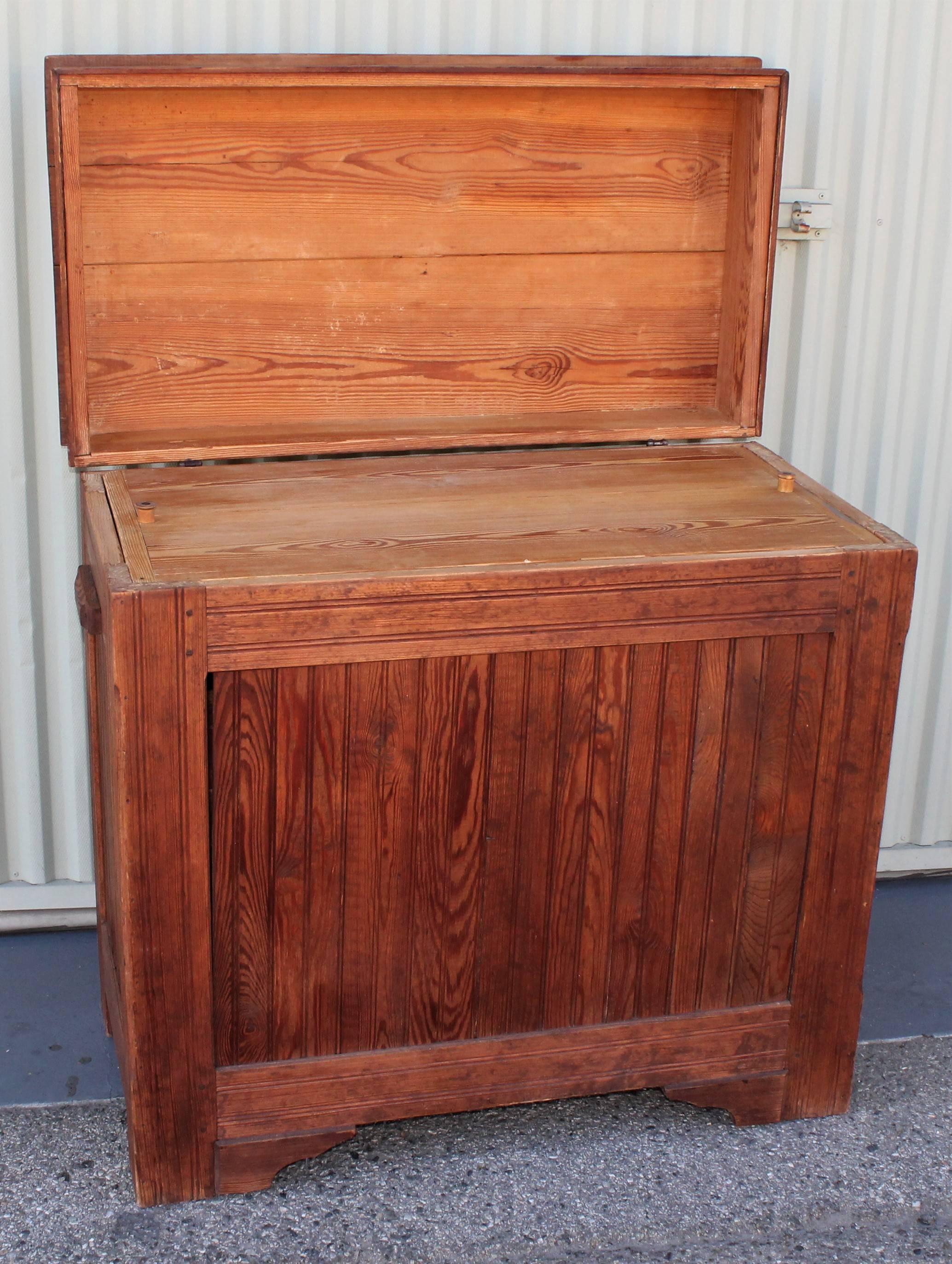 19th century raw pine with a Fine patina from age, this flour bin has a cool lift top with inlaid dough board or cutting board. The sides have handles for lifting or moving around. The condition is very good. This bin looks like the mid west.