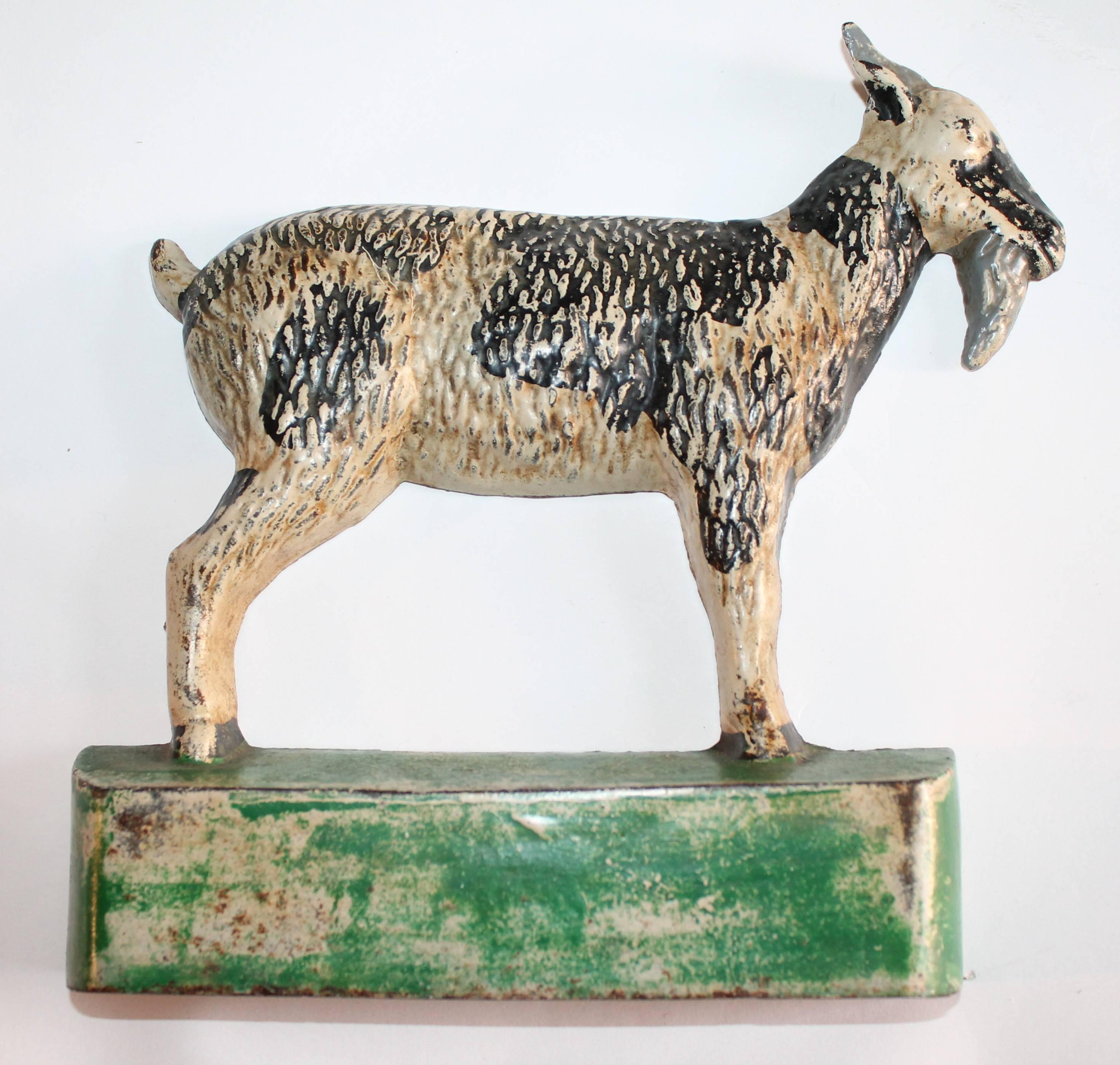 This early 20th century original painted cast iron goat is in good condition with wear consistent from age and use.