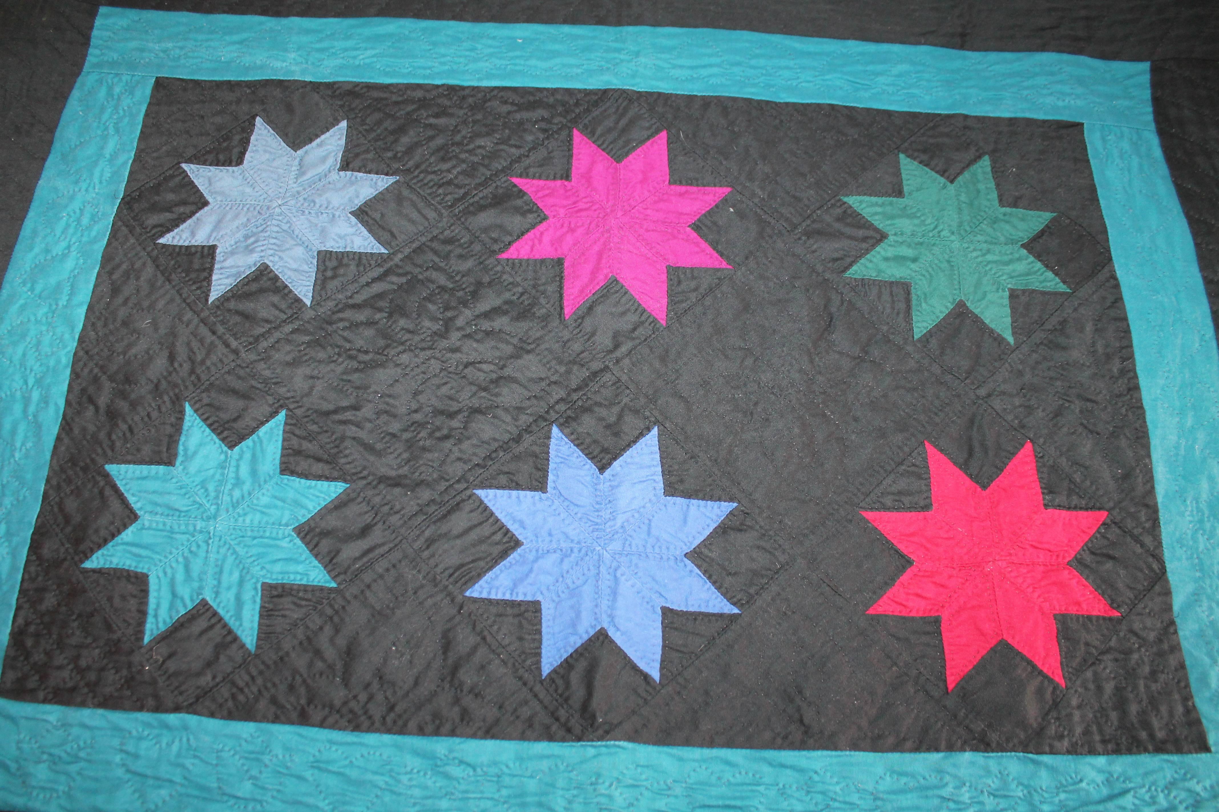 This fine Ohio Amish eight point stars is in fine condition with a grey chambray backing. This little rare gem has nice tight stitching and wonderful piece work as well. It is rare to find these forties crib quilts in fine condition. Ready for