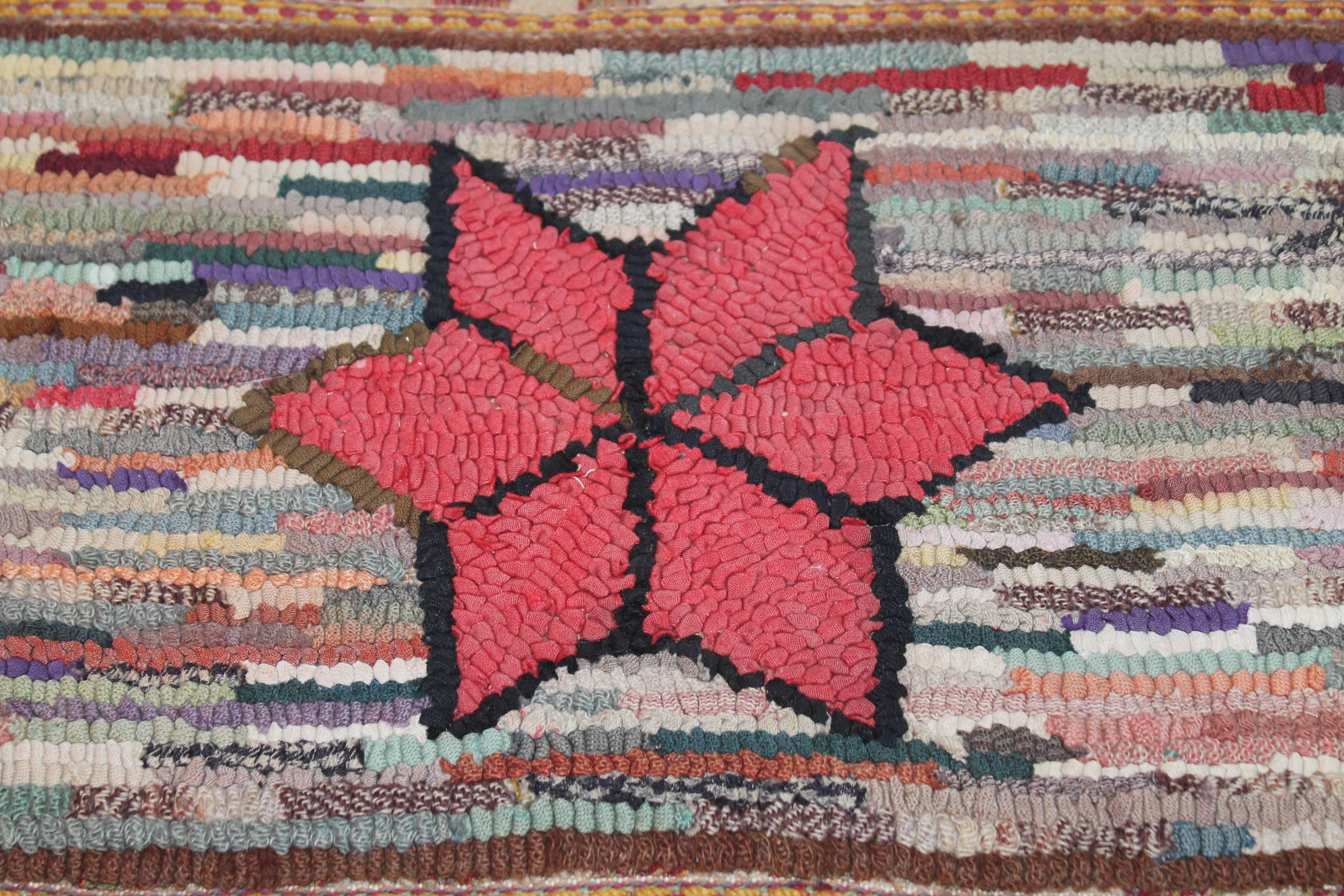 This amazing little gem is very early example of a sampler or child's hand hooked rug mounted on stretcher frame. The entire rug including the fringe is hand woven in very early country colors. It is all hand-sewn on cotton linen.