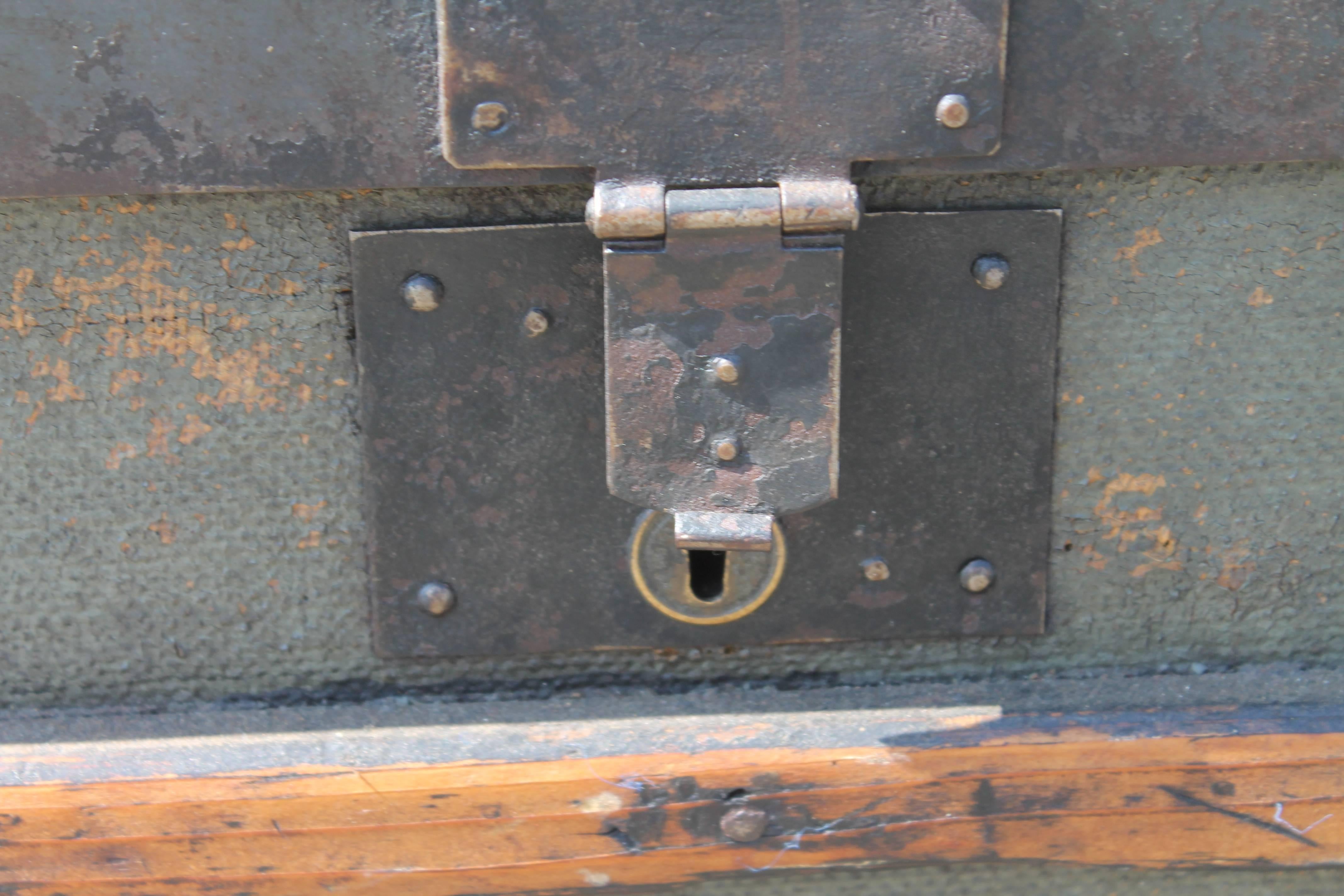 This cool original painted dome top trunk looks like an early army trunk. The paint is in a army green on a oilcloth surface and is all wood with metal trim and hardware. The handles on the side are old leather and probably replacements as they are