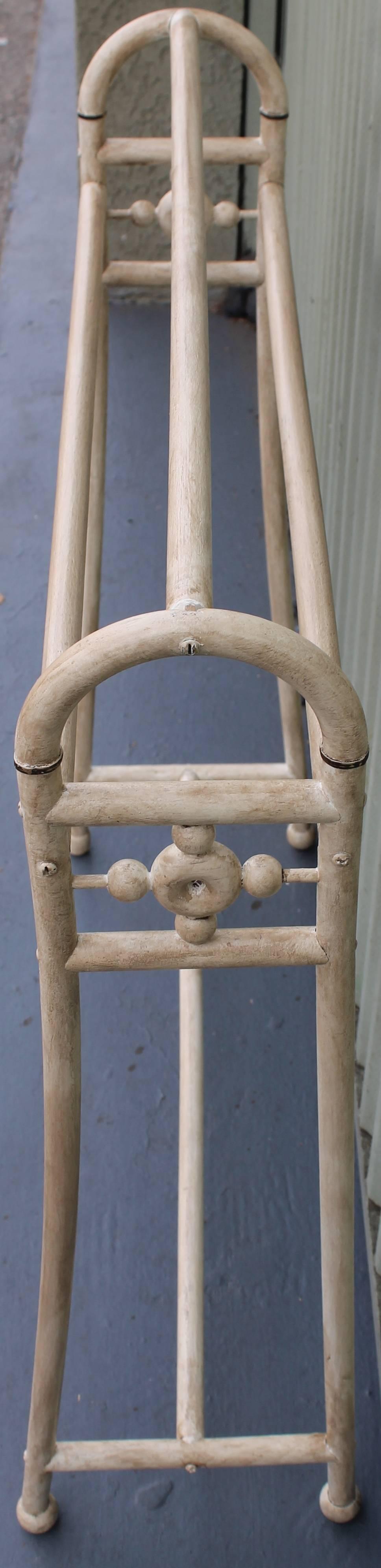 This wonderful cream painted quilt rack is in a nice mellow distressed painted surface. It is very sturdy and has all the original hardware. It holds three quilts or blankets.