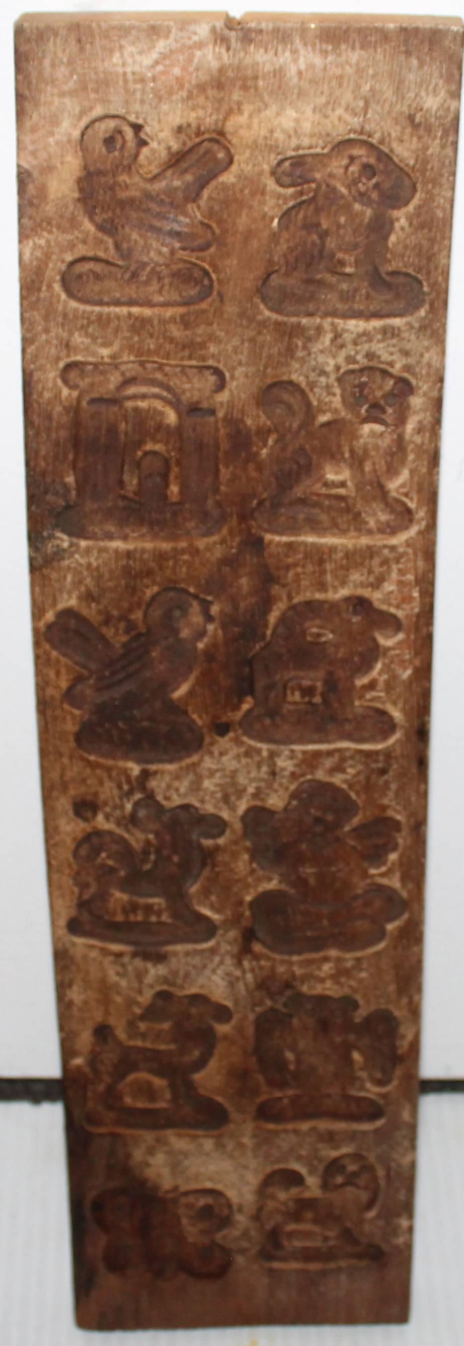 This unusual long hand-carved wood chocolate mold is in good condition. Great hanging on a wall in a kitchen.