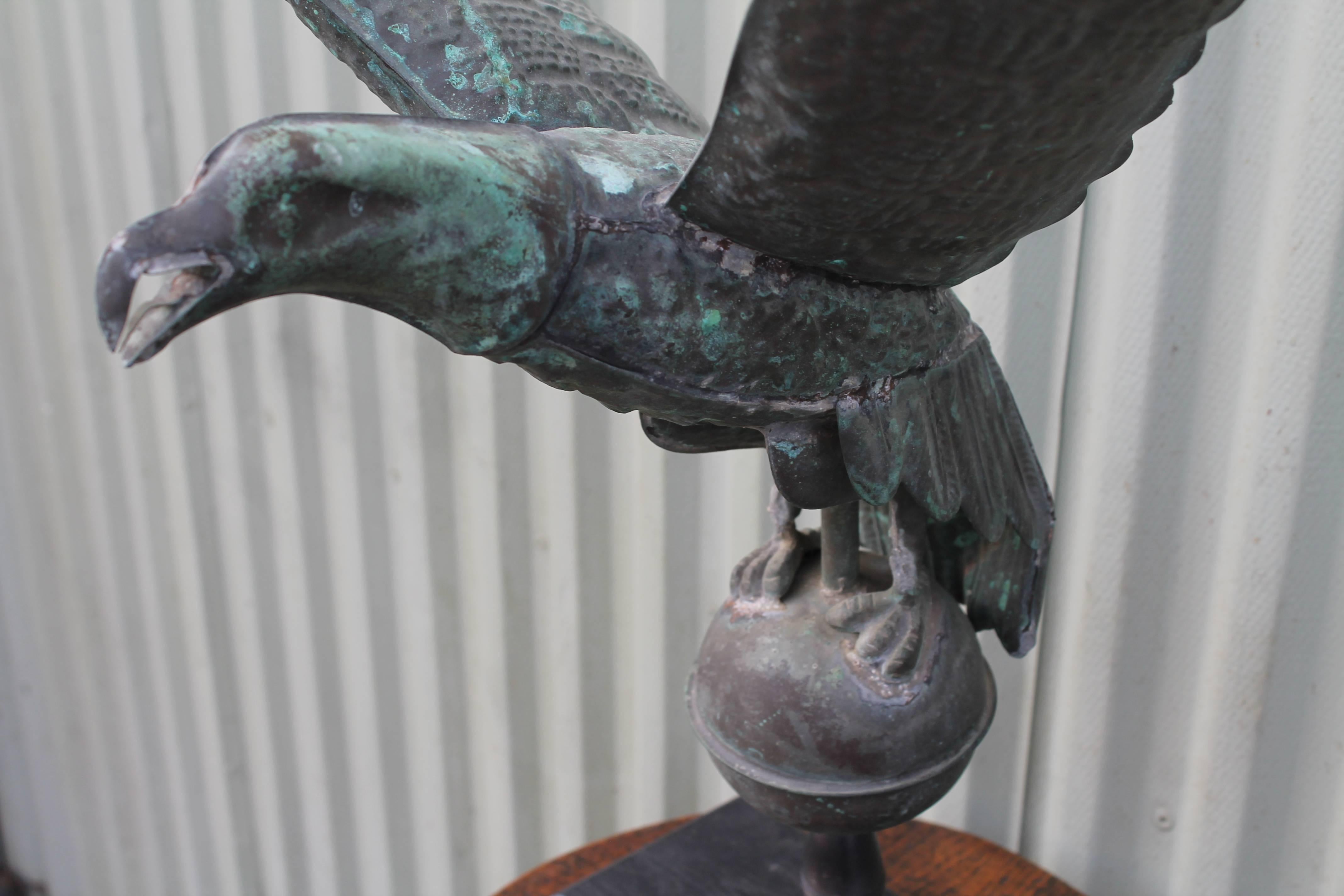 19th century full body copper eagle weathervane. This item has been professionally mounted on an iron mount. The verdigris surface is amazing and throughout? Wear is consistent with age and use. Minor dent on back side of ball.