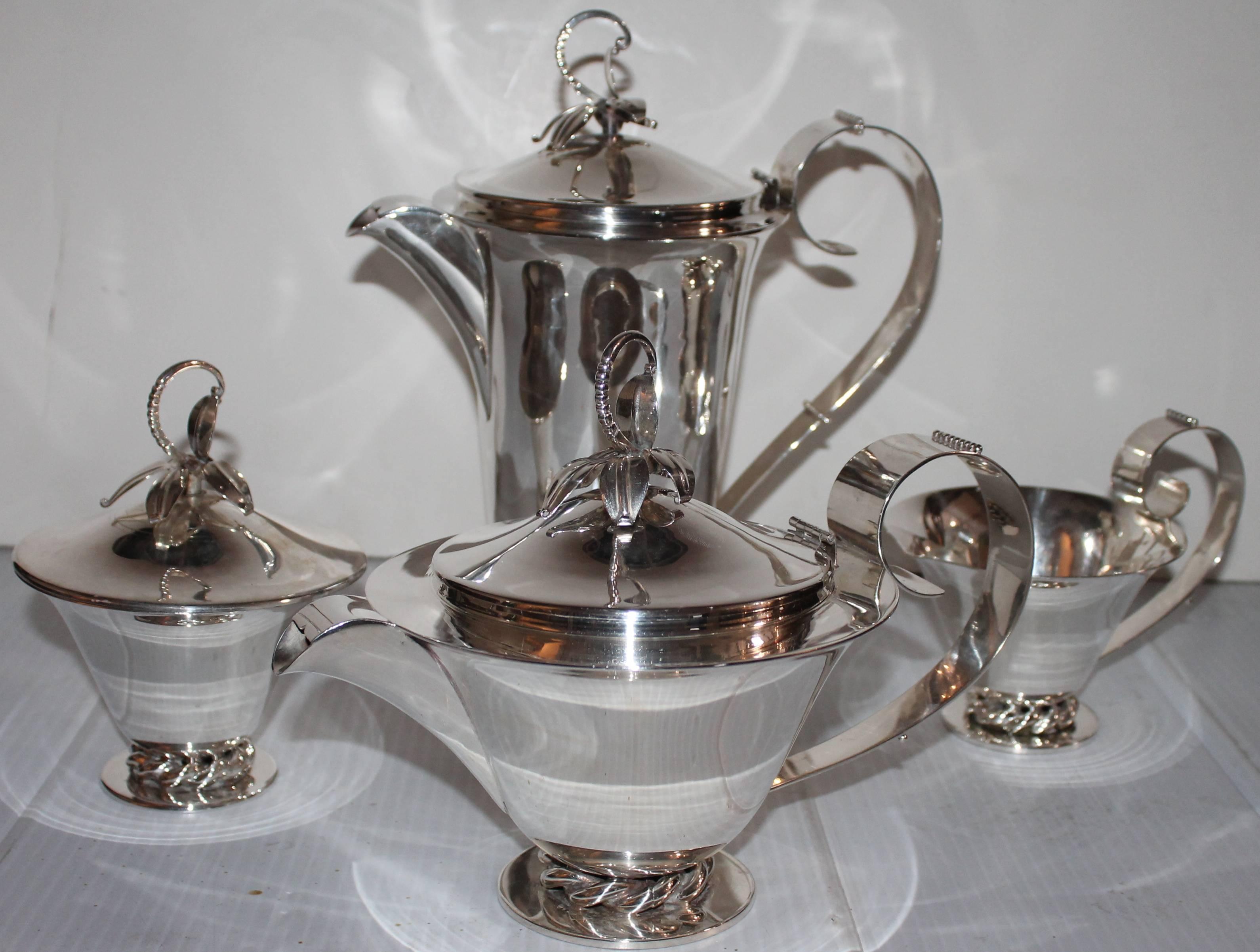 Three Crowns silver plate tea set. Coffee pot, sugar and creamer and cup.
Marked with Three Crowns, Royal Hickman. 
Measures: Creamer 7 x 7 x 10.
Sugar 6 x 5.
Cup 7 x 5.
 