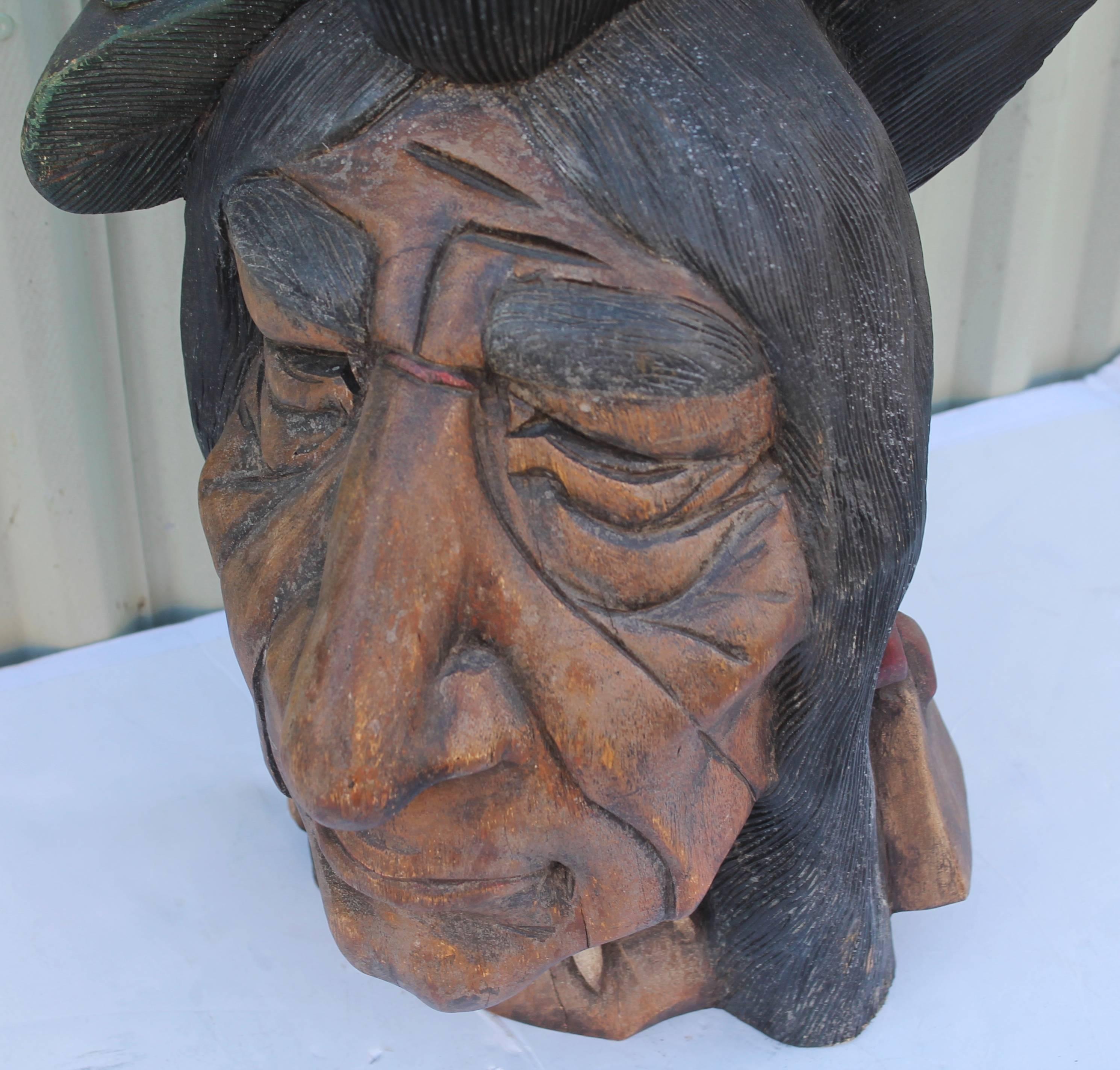 19th century hand-carved and painted cigar store Indian head. This size Indian head was used in the windows or store counters in the cigar shop. The heads are a little harder to find then the full body cigar store Indian. The face has been repainted