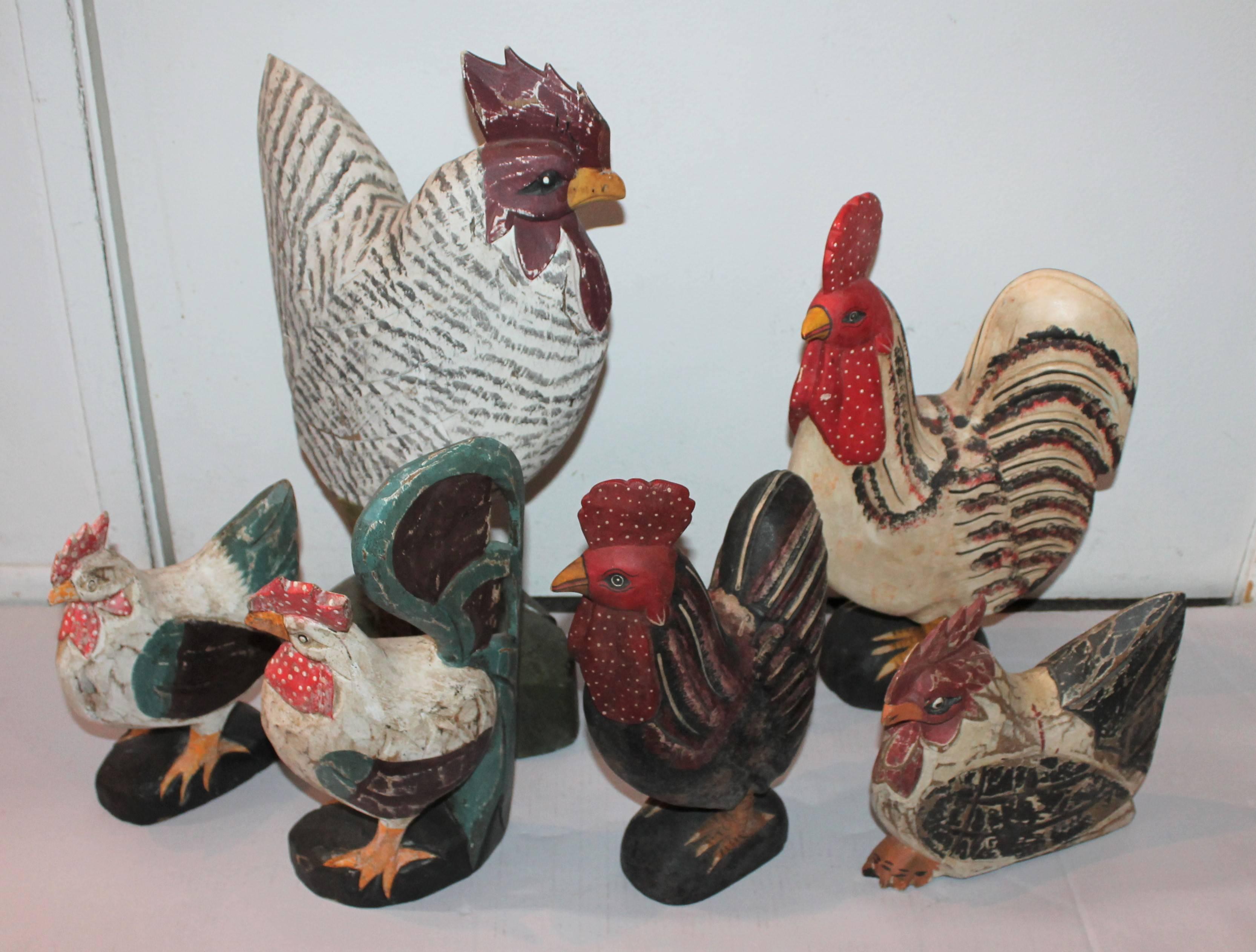 Group of three Folk Art hand-carved and painted wood roosters from Mexico. These wonderful and folky hand-carved wood roosters are all different and in good condition.