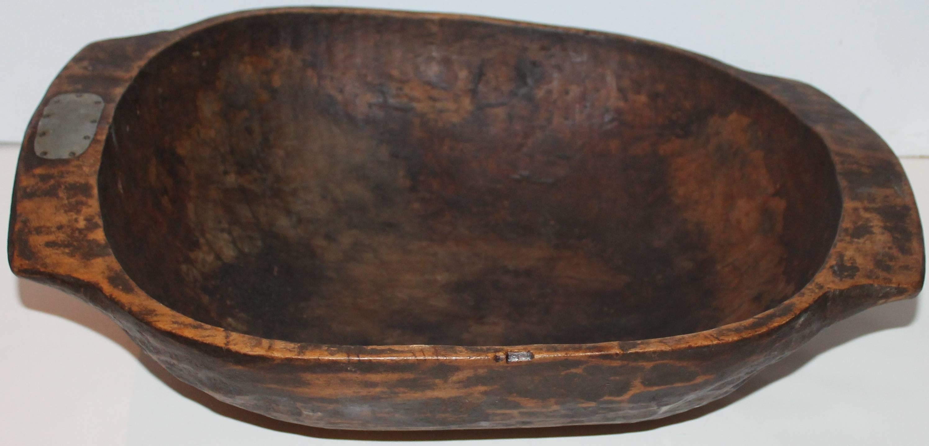 This wonderful hand-carved dough bowl or trencher is in great condition with a wonderful old surface. The patina is the best and untouched. There are no cracks but a small little repair on the handle.