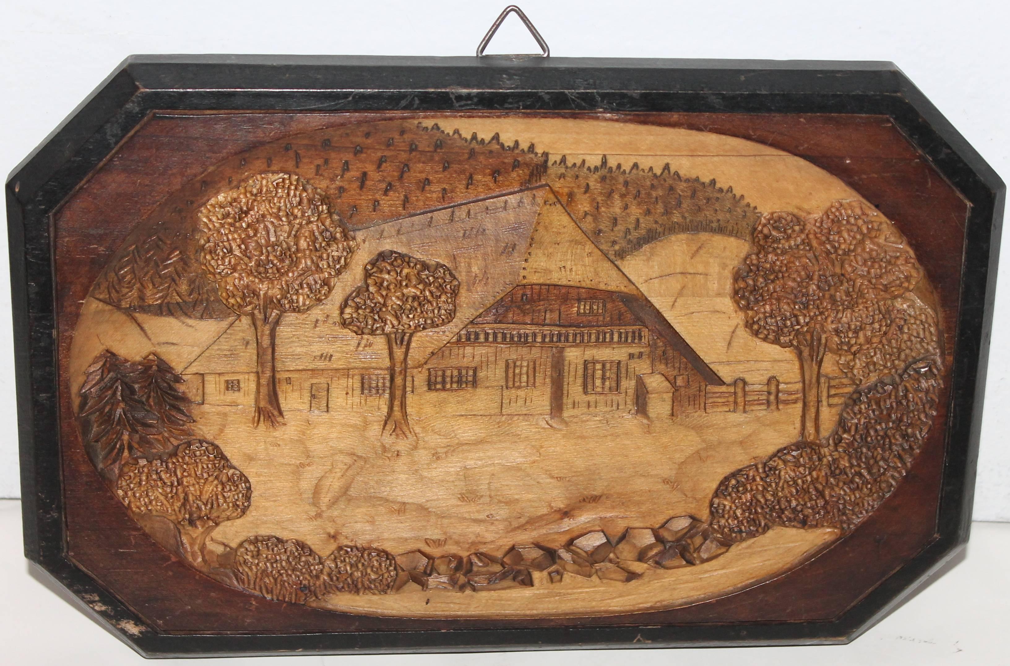 This hand-carved image of a cabin in the mountains is in amazing condition. This is all hand-carved and in great as found condition. This folk art plaque is unsigned.