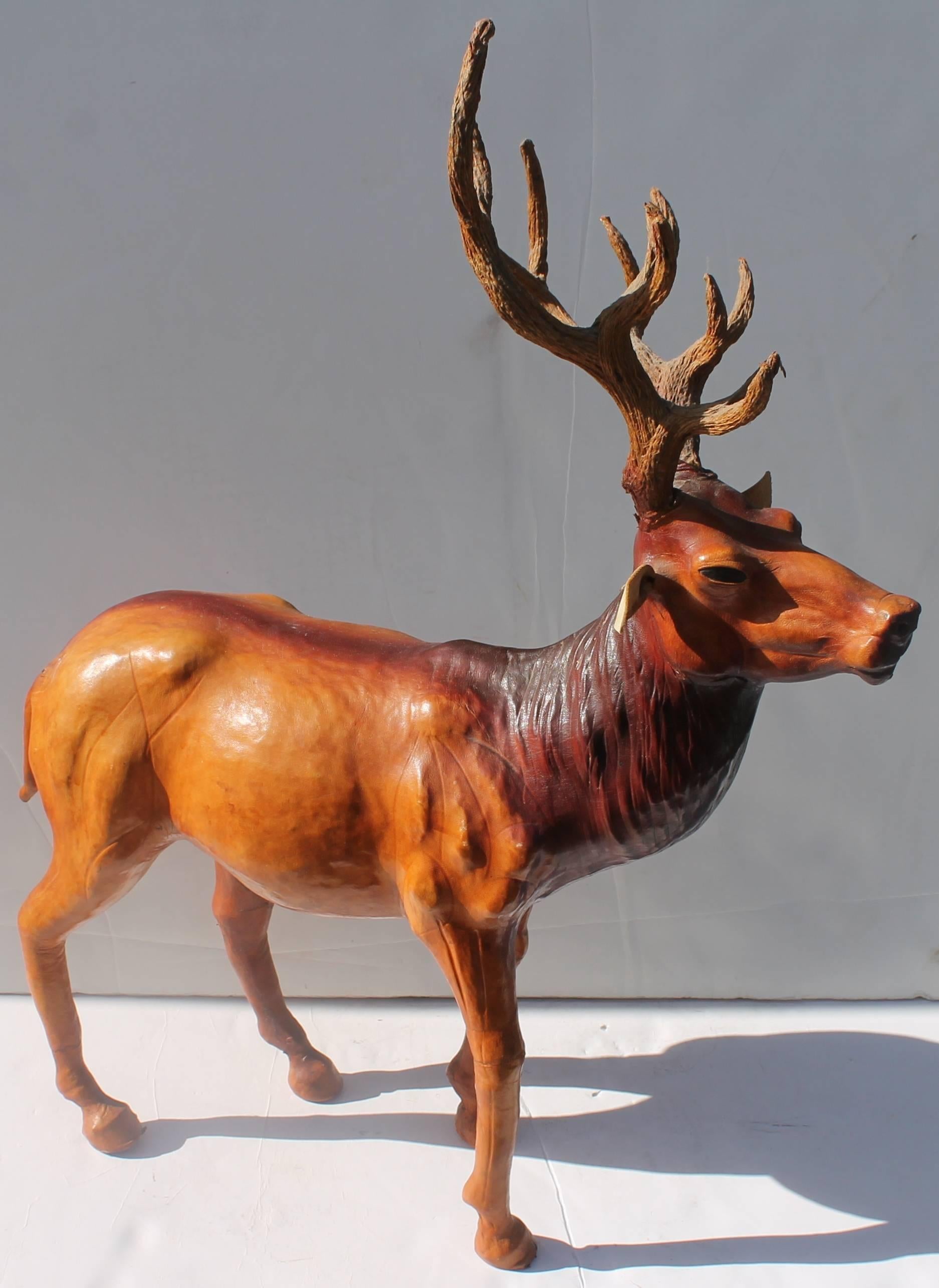This handmade hollow body leather elk has leather horns and cool glass eyes. Condition is very good. This is most unusual as you usually just see leather horses made in this format.