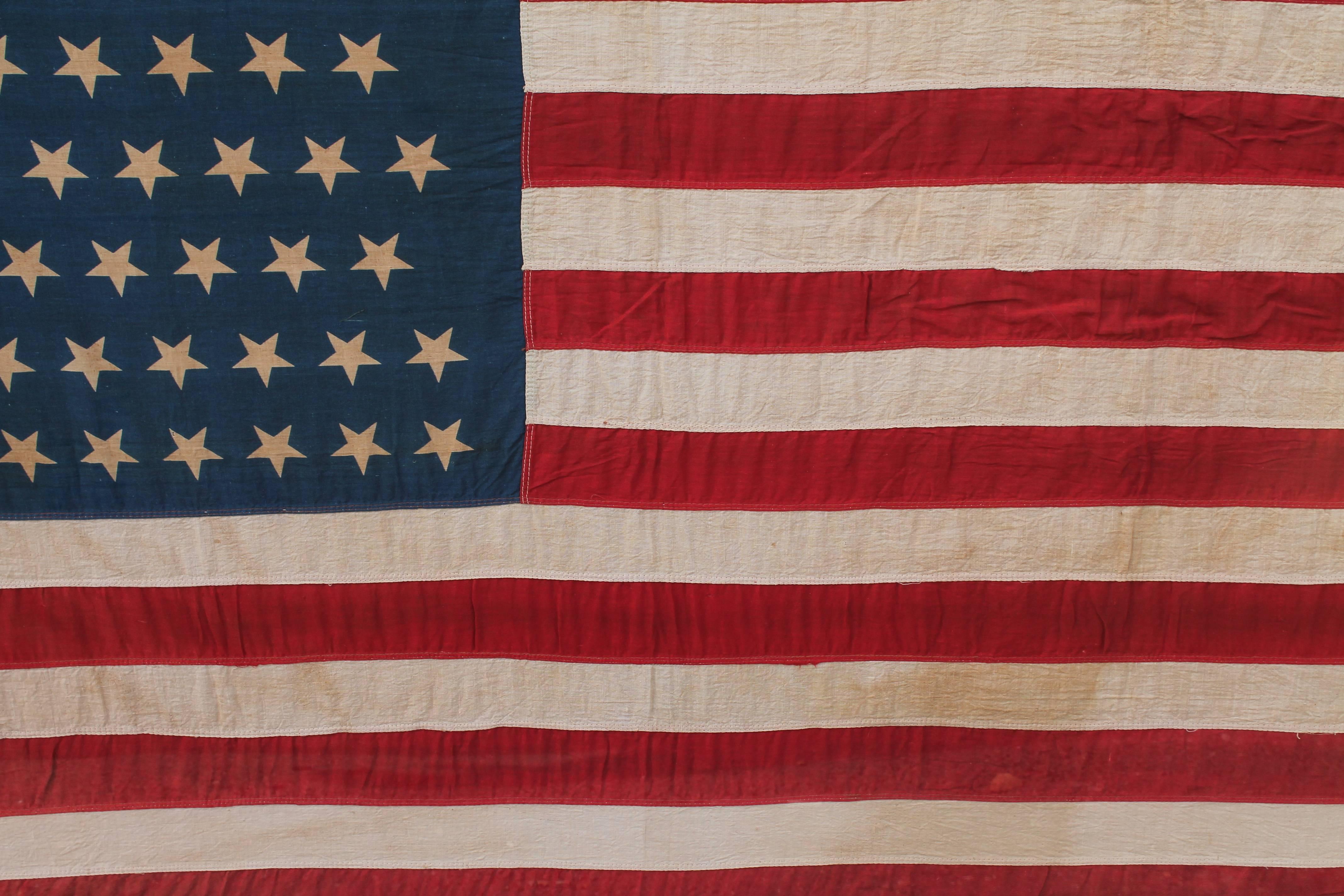 This monumental framed flag is in very good condition and is framed in a custom-made blue wood frame. The cover is in plexy. This flag was from July 4th in 1909.