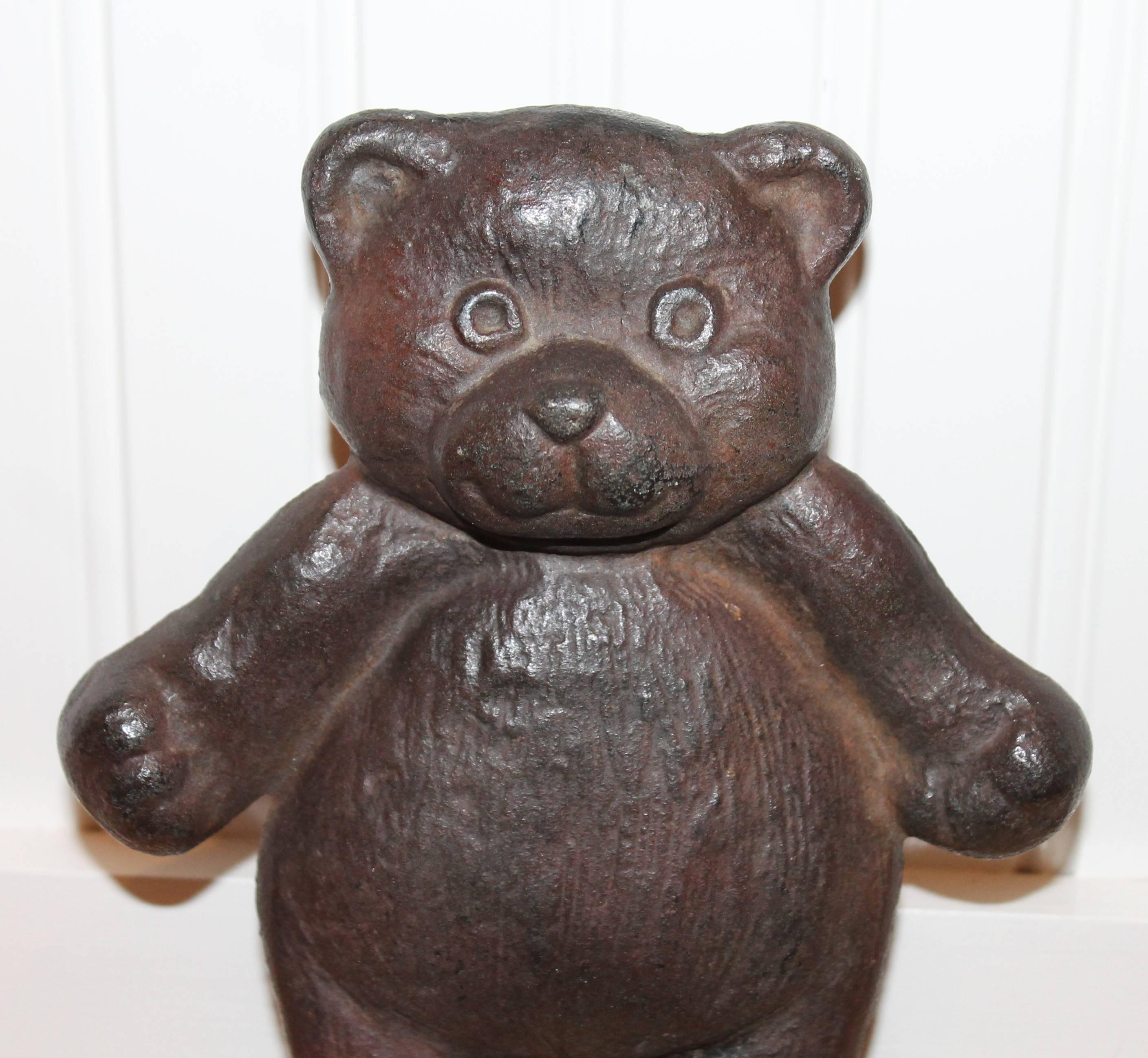 This very cool teddy bear doorstop is cast iron and is dated 1910 on the back side. The condition is very good with a nice patina.