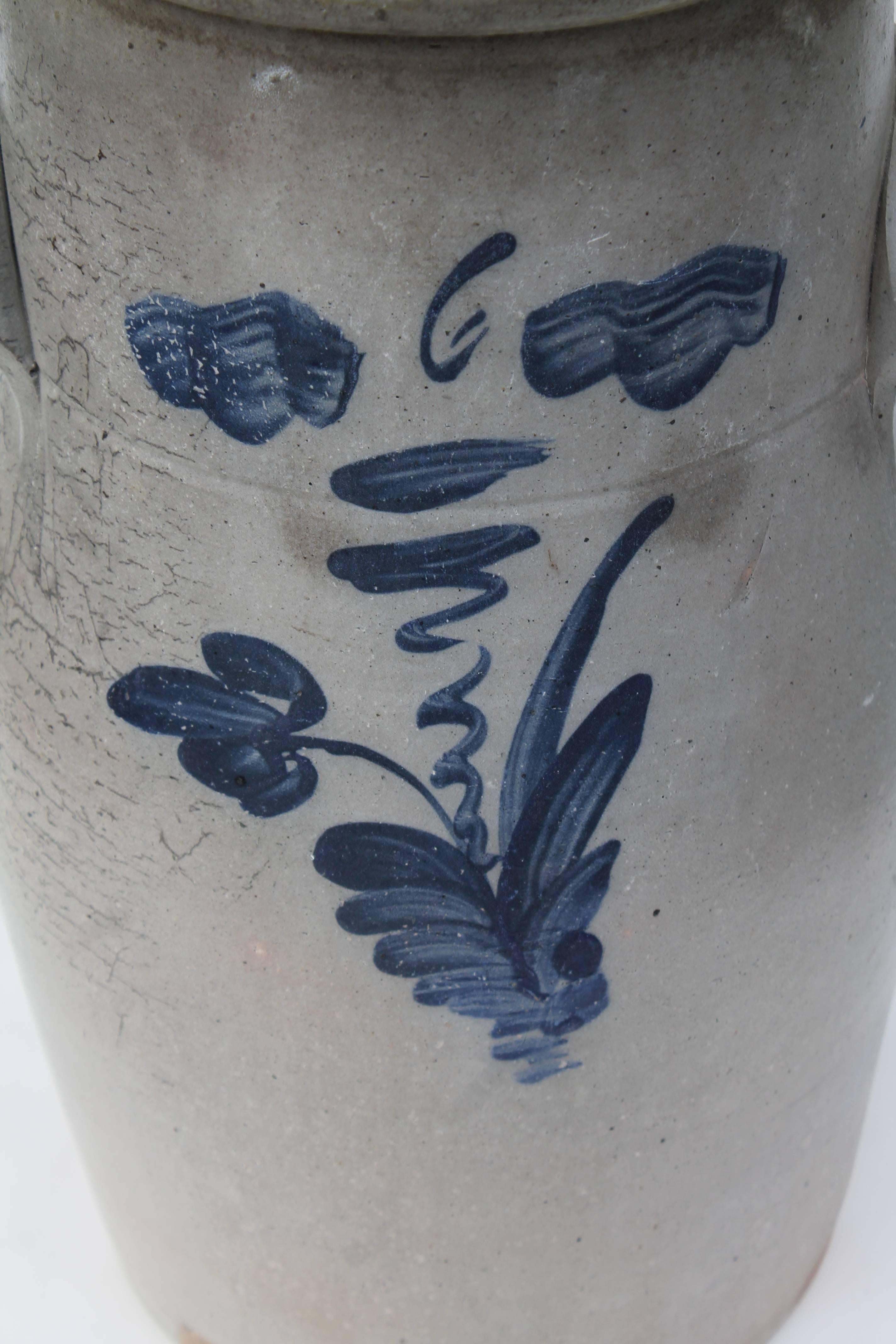 This amazing large six gallon and two handled hand decorated crock is in pristine as found condition with minor age marks and crazing. This handmade crock appears to be a tall butter churn crock. The decorated crock was from a collection in