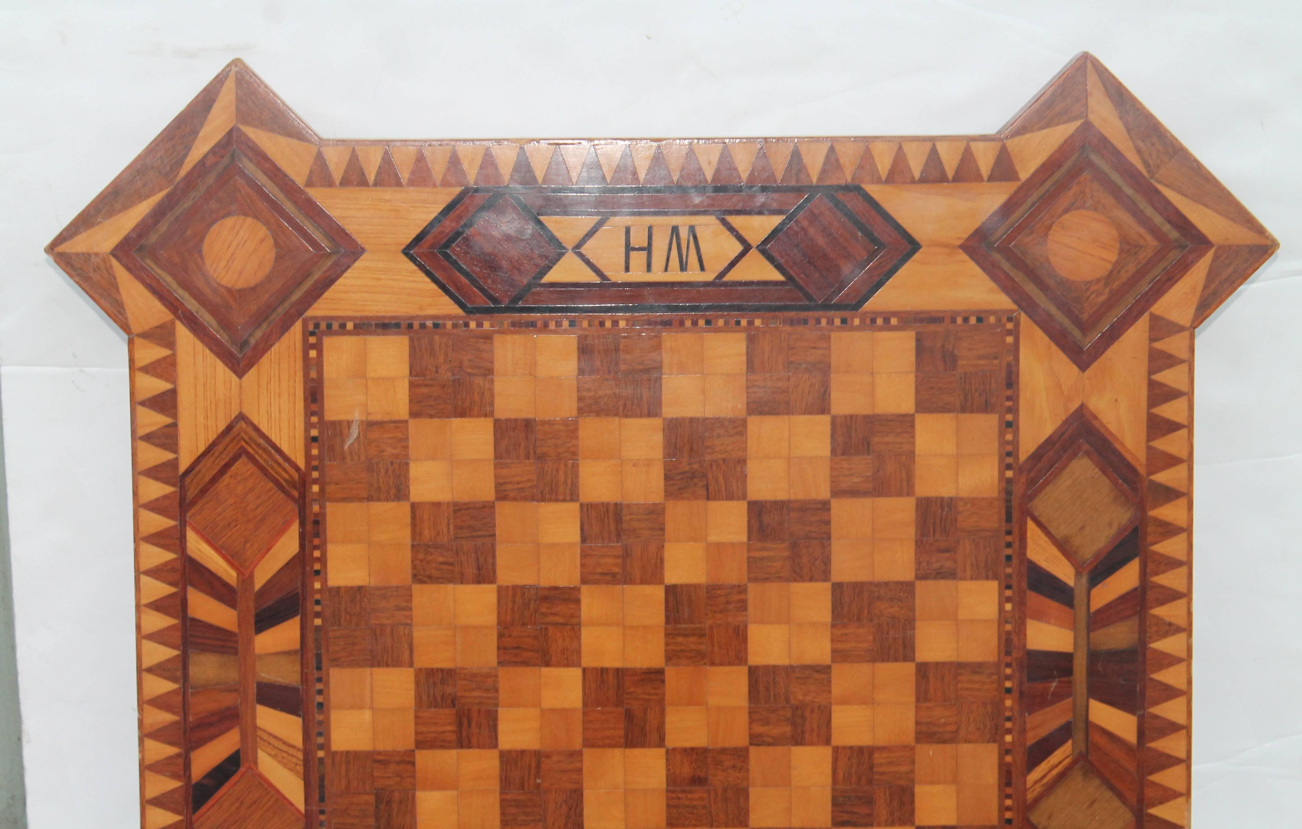 This is a amazing tabletop game board. It is all hand inlaid and in pristine condition. This chess board was made for William Ryan Henderson by Aurthur Wright. It took one and half years to make it. It is signed and dated 1955. It is made up of many