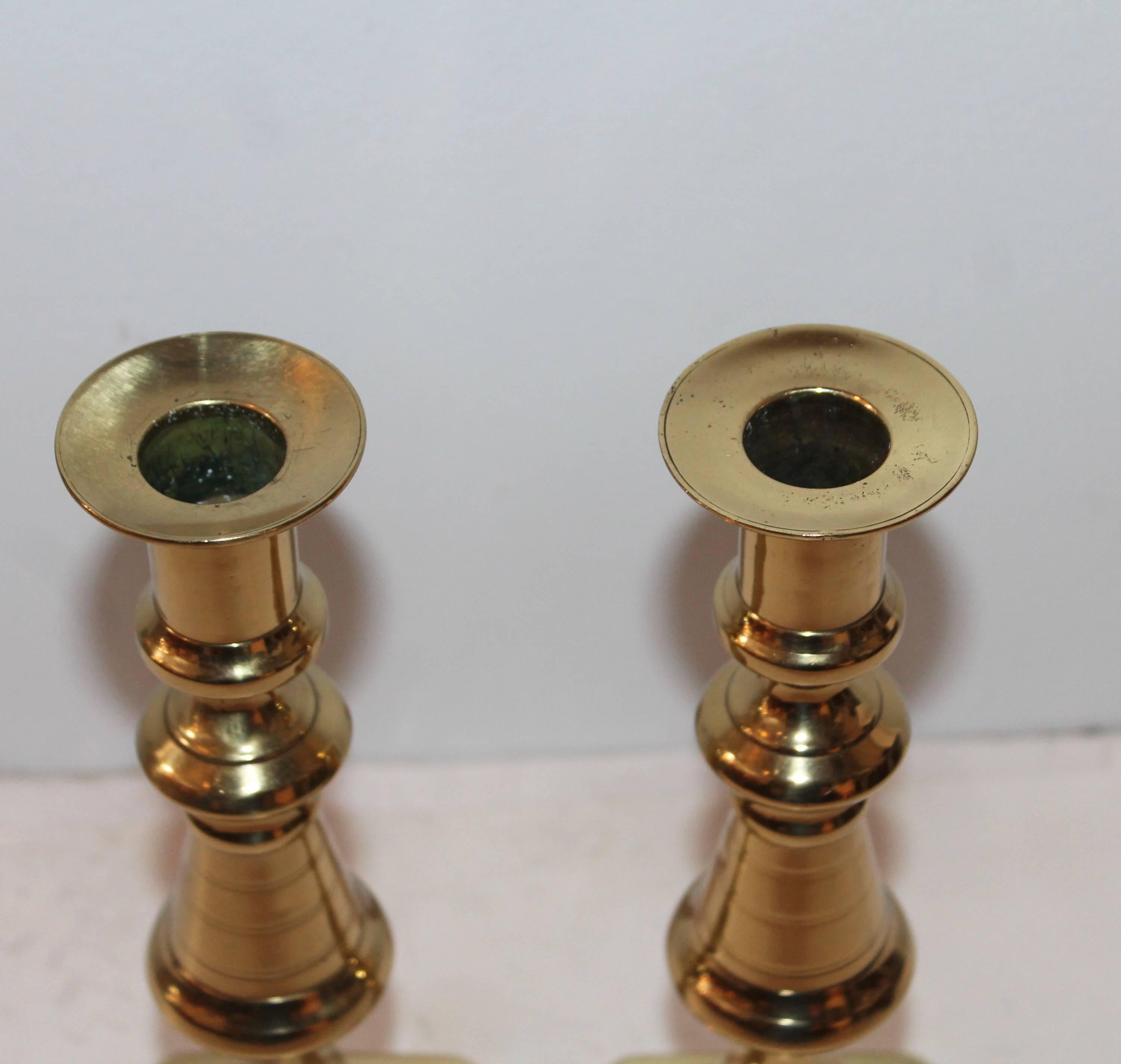 Pair of polished brass candlestick holders. This pair was found in New England and are in wonderful as found condition.