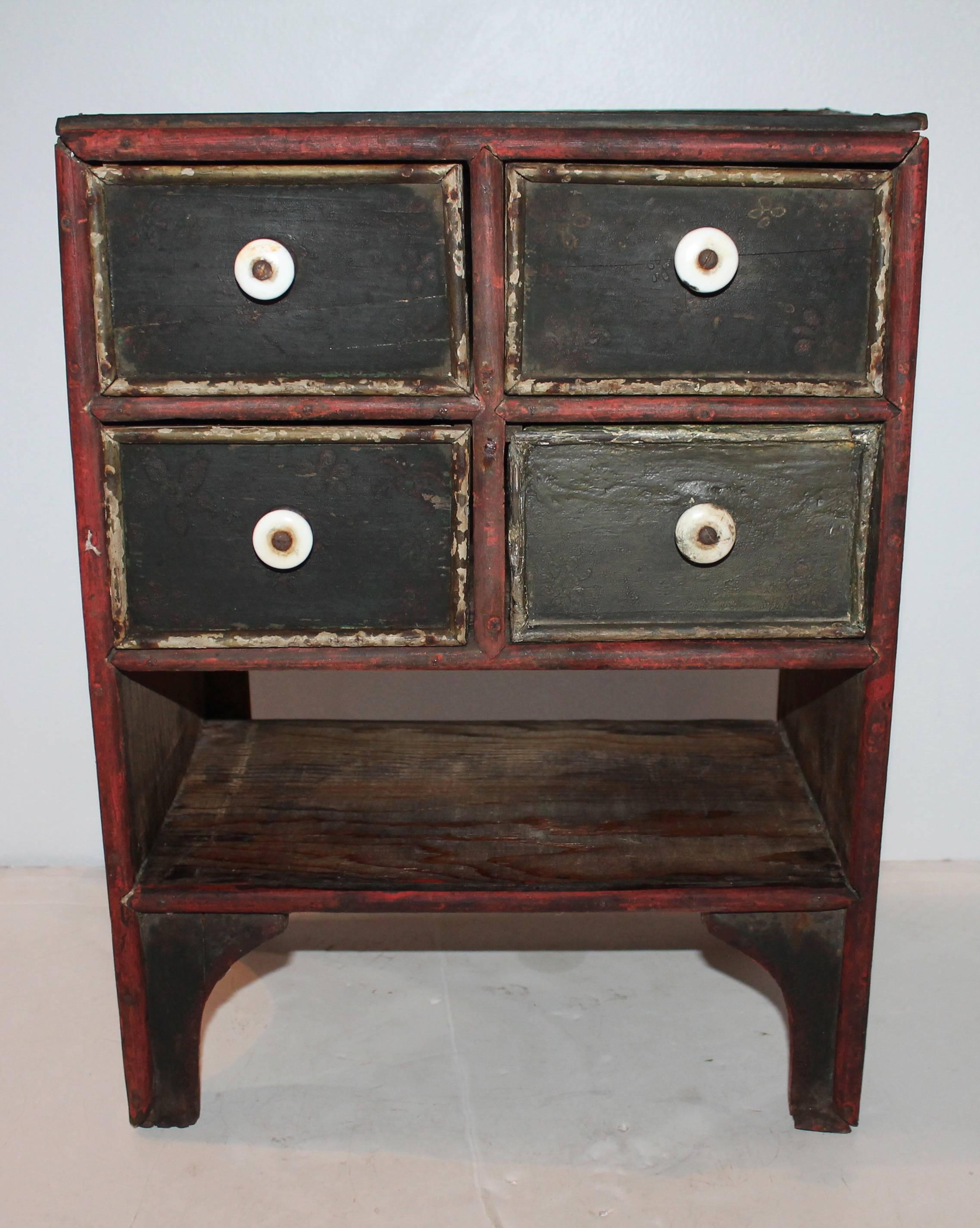 This amazing fancy paint decorated tabletop 19th century apothecary cabinet has all the original drawers and hardware with tiny cut nail construction. The decoration has a hex sign or Pennsylvania Dutch symbol on the top and both sides. There is no