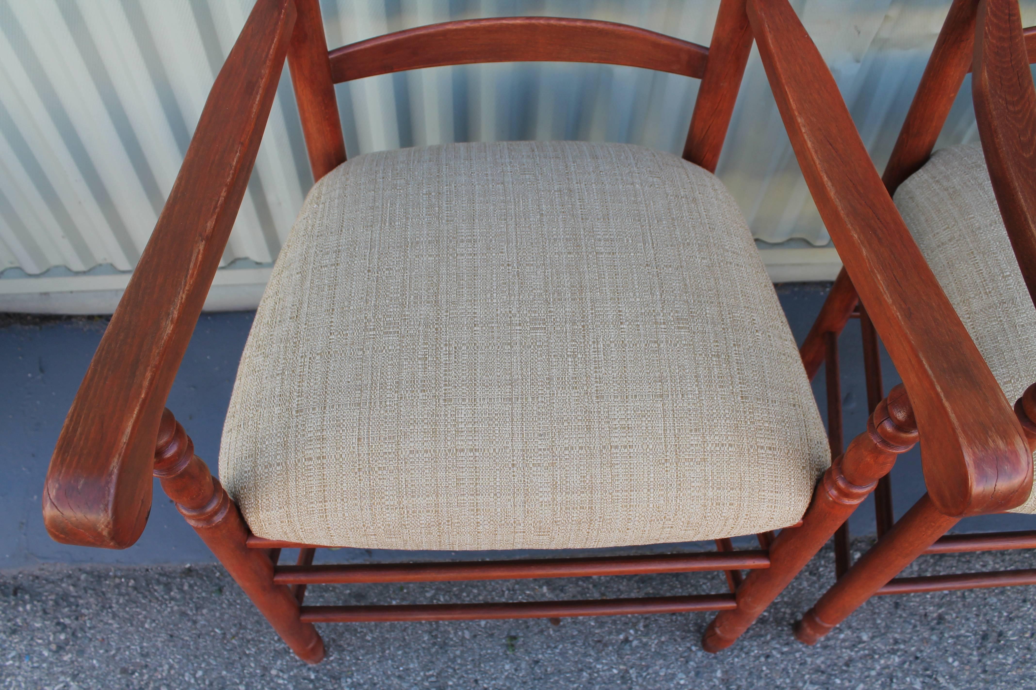 This is the most amazing matching pair of red painted ladder back arm chairs from New England. The seats are newly upholstered in a tan durable linen. The chairs are very strong and sturdy. They are super comfortable. The chairs have a amazing