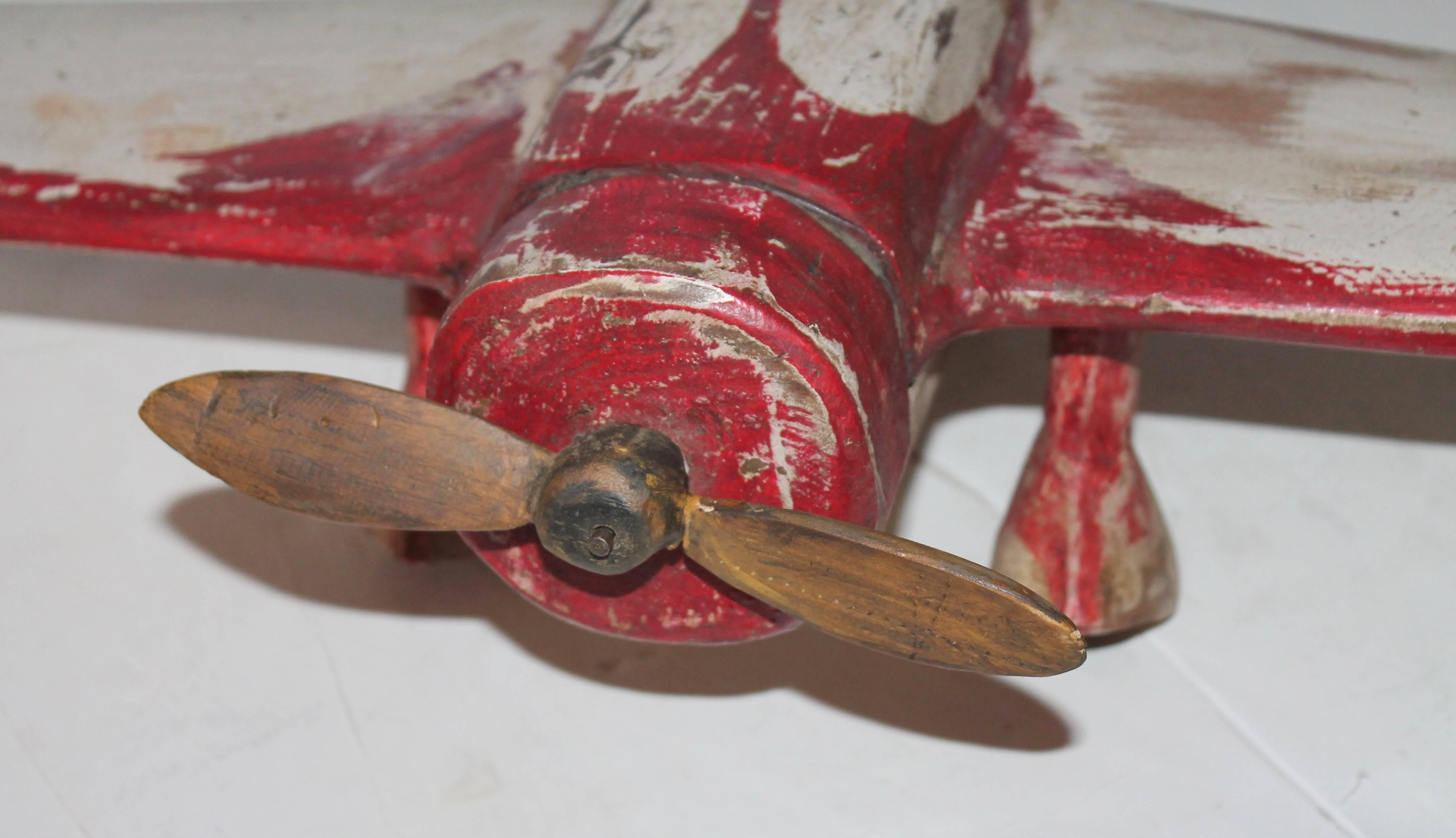 This folky airplane is quite cool and very rustic. It has a wonderful worn patina and is functional for a kids to play with. It looks more like a piece of Folk Art.