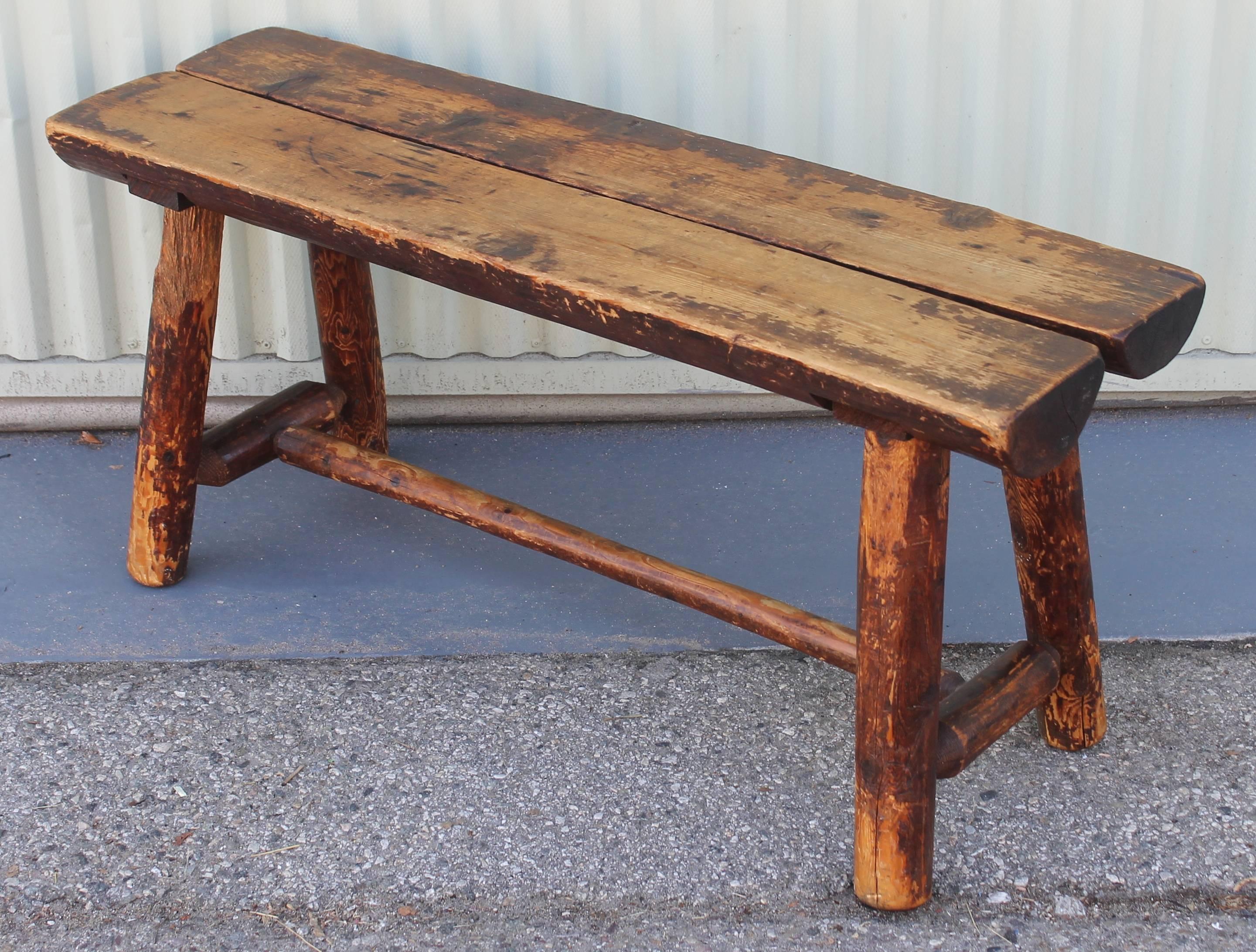 This fine worn bench / table was found in Pennsylvania and is in great sturdy condition. It has a wonderful mellow patina with a undisturbed surface. This bench or table is great at the end of a bed or as a small coffee table. Great rustic cabin