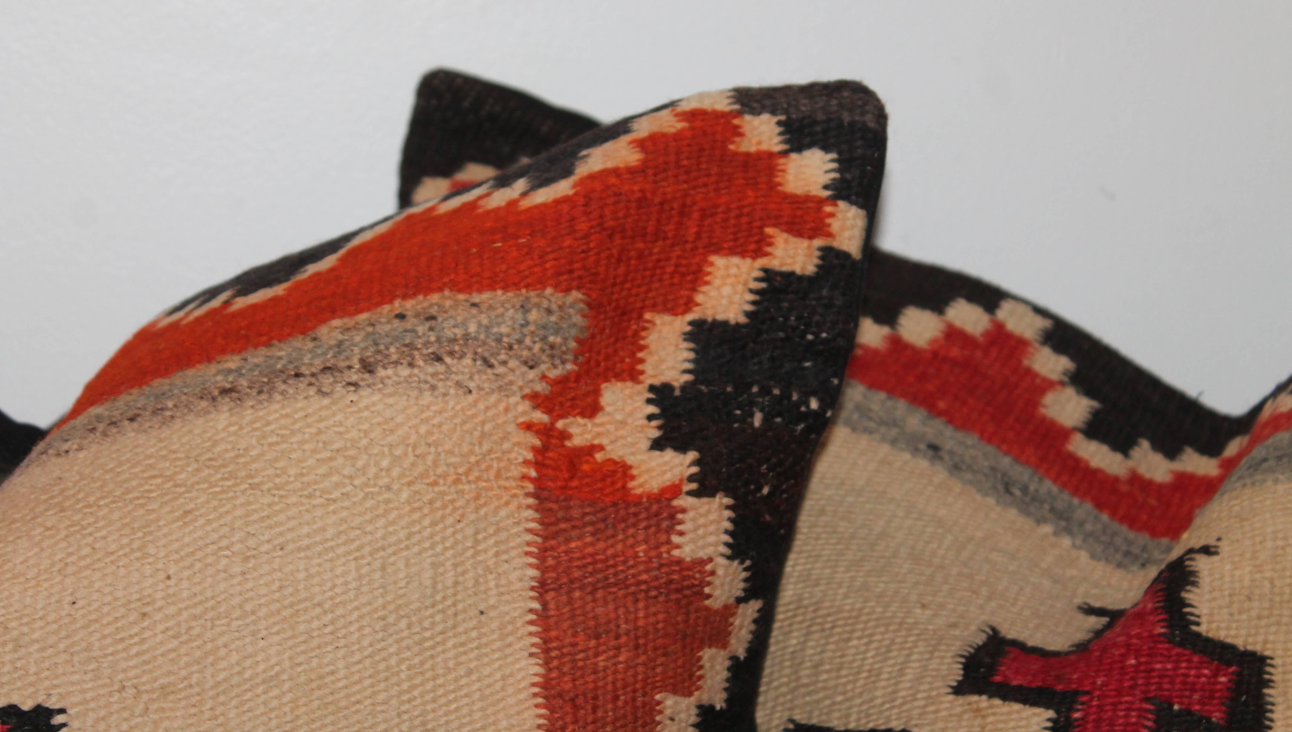 These large bolster pillows are from a early 19th transitional Navajo Indian weaving and have black cotton linen backing. The pillows are sold as a matched pair.