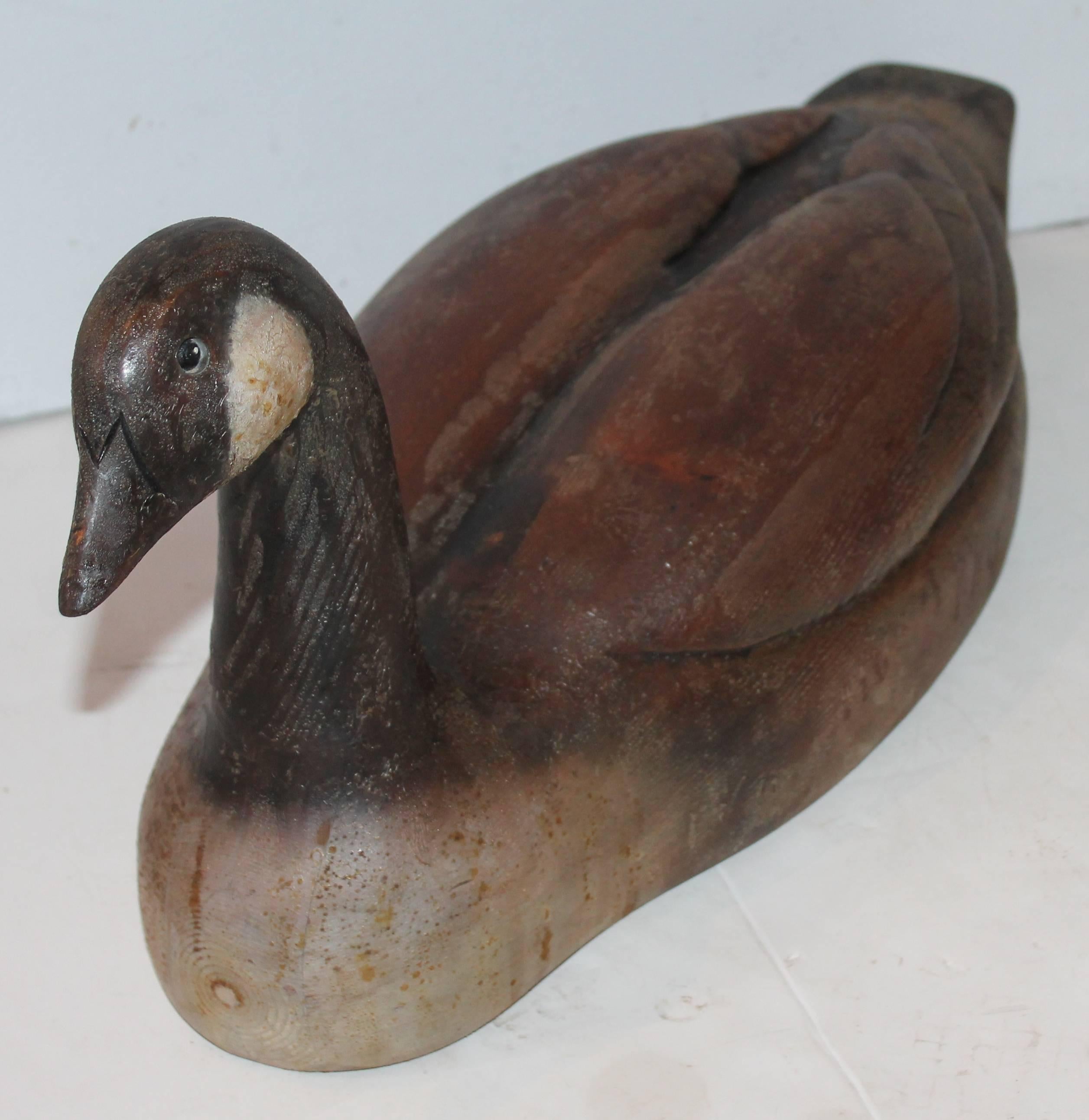 This fantastic decoy has such great form and paint. It is also signed by the by Cranford. It is a very heavy and well carved goose. Late but great! The condition is very good with minor wear and oxidation consistent with age and use. Possibly stored