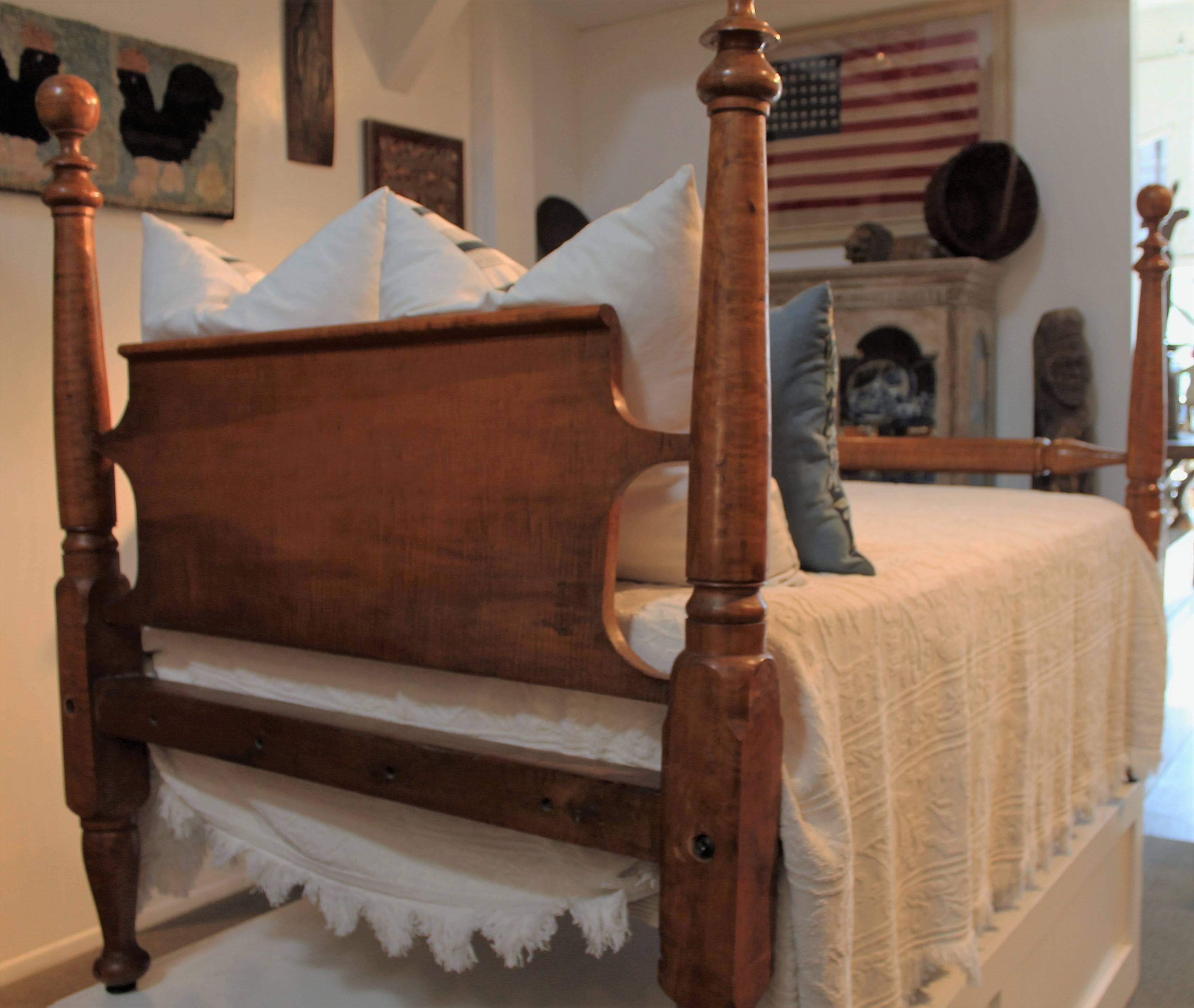 This four-poster bed bird's-eye maple bed is in very good and sturdy condition. The headboard is a flat rolled back panel. The 3/4 bed frame comes with a custom-made box spring and mattress. The iron brackets hold the box spring in place perfectly.