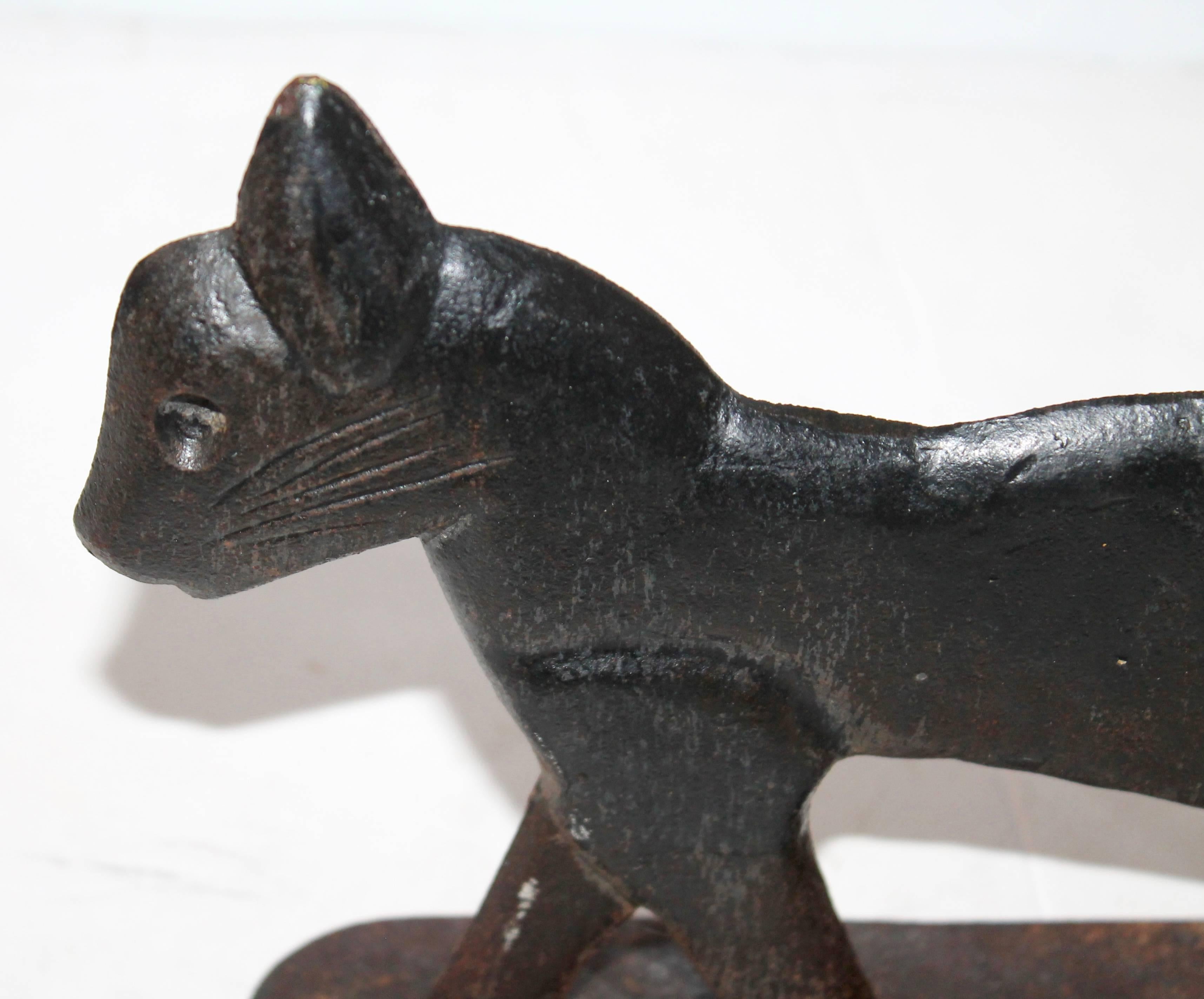 This folky and fun cast iron cat could be used as a door stop but was original for scrapping mud off the boots. The condition is very good.