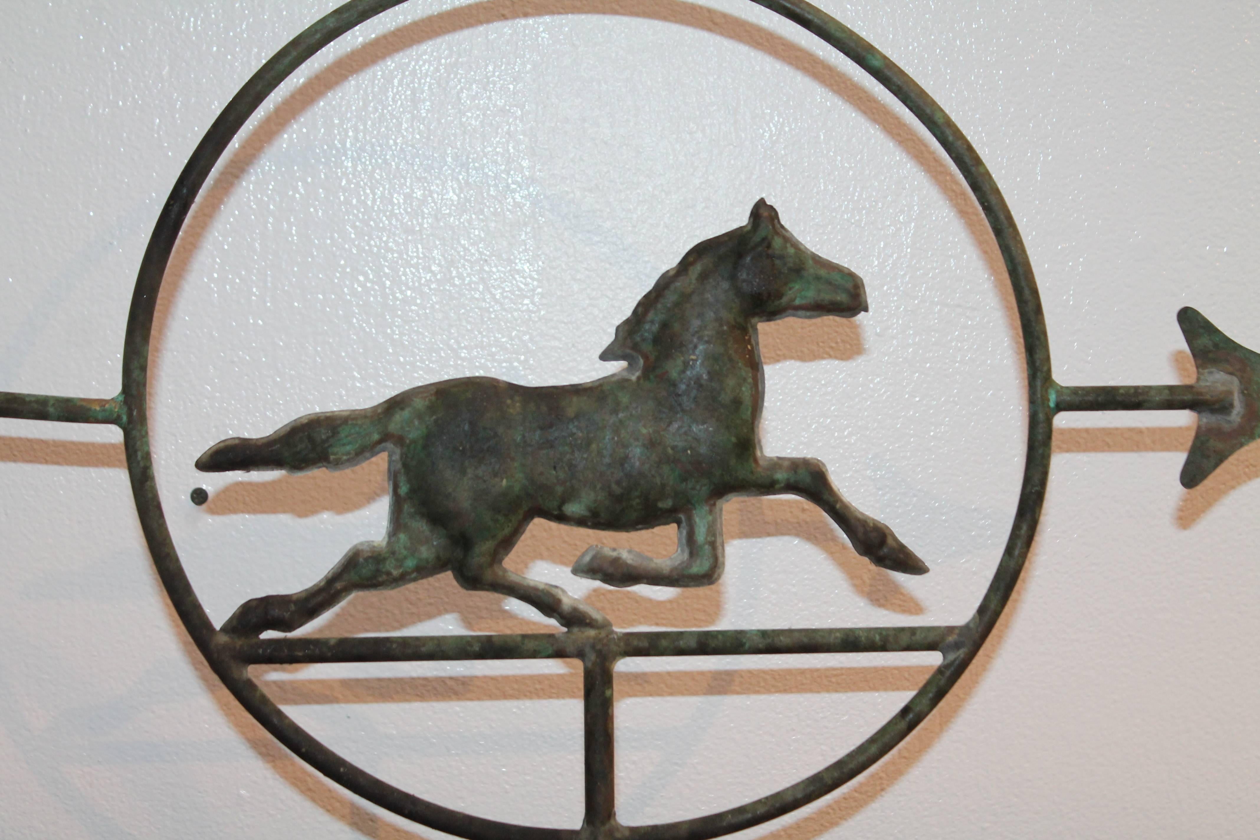 This custom-made cast iron mounted copper running horse weathervane is a diminutive horse within the circle and arrow is in wonderful as found condition. This late 19th century horse retains a great aged patinaed surface. The entire weather vane is