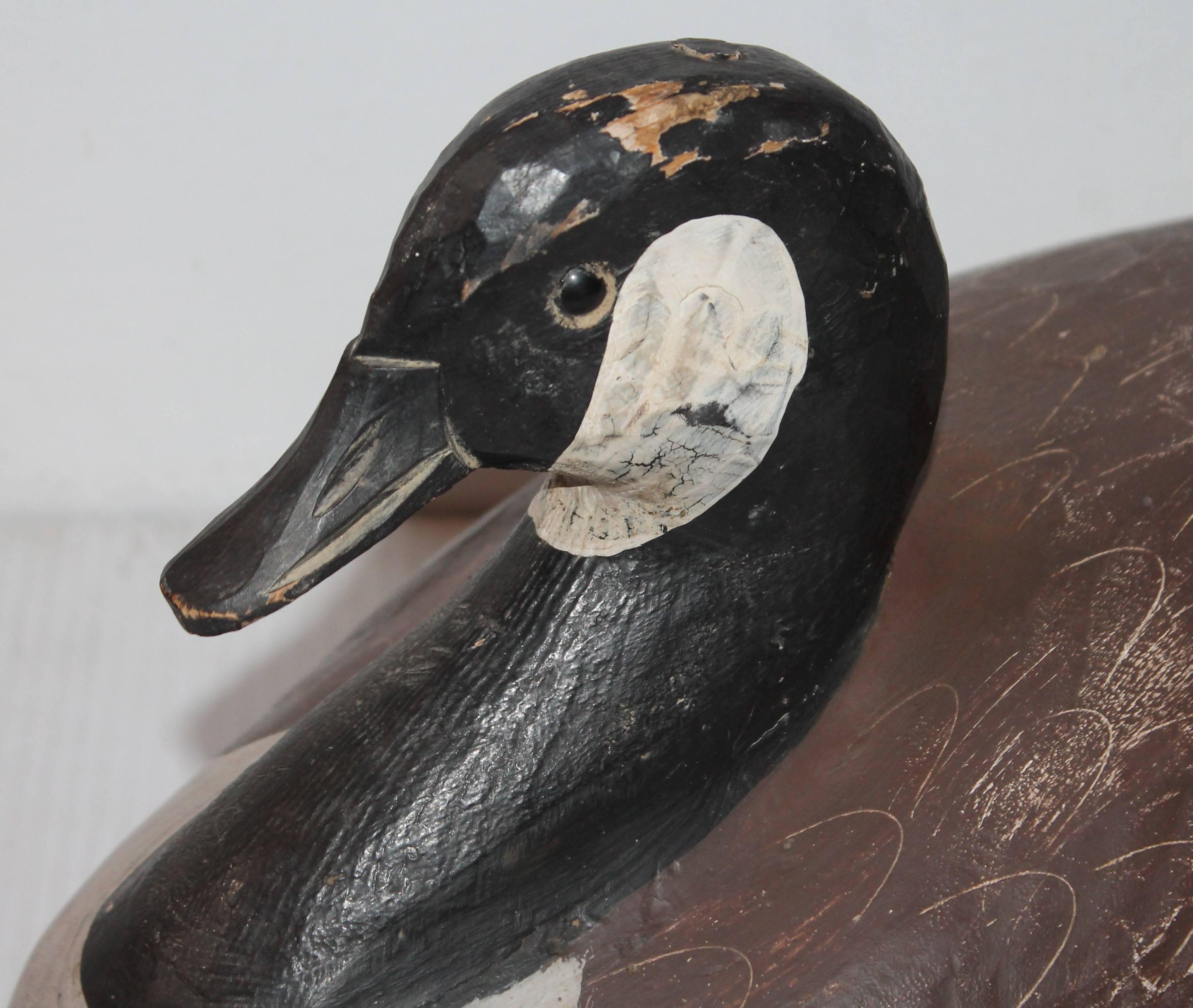 This fine example of Folk Art carved goose is in great as found condition. Minor wear consistent with age and use. This is a very heavy and solid bird. Wonderful details in the painted surface.