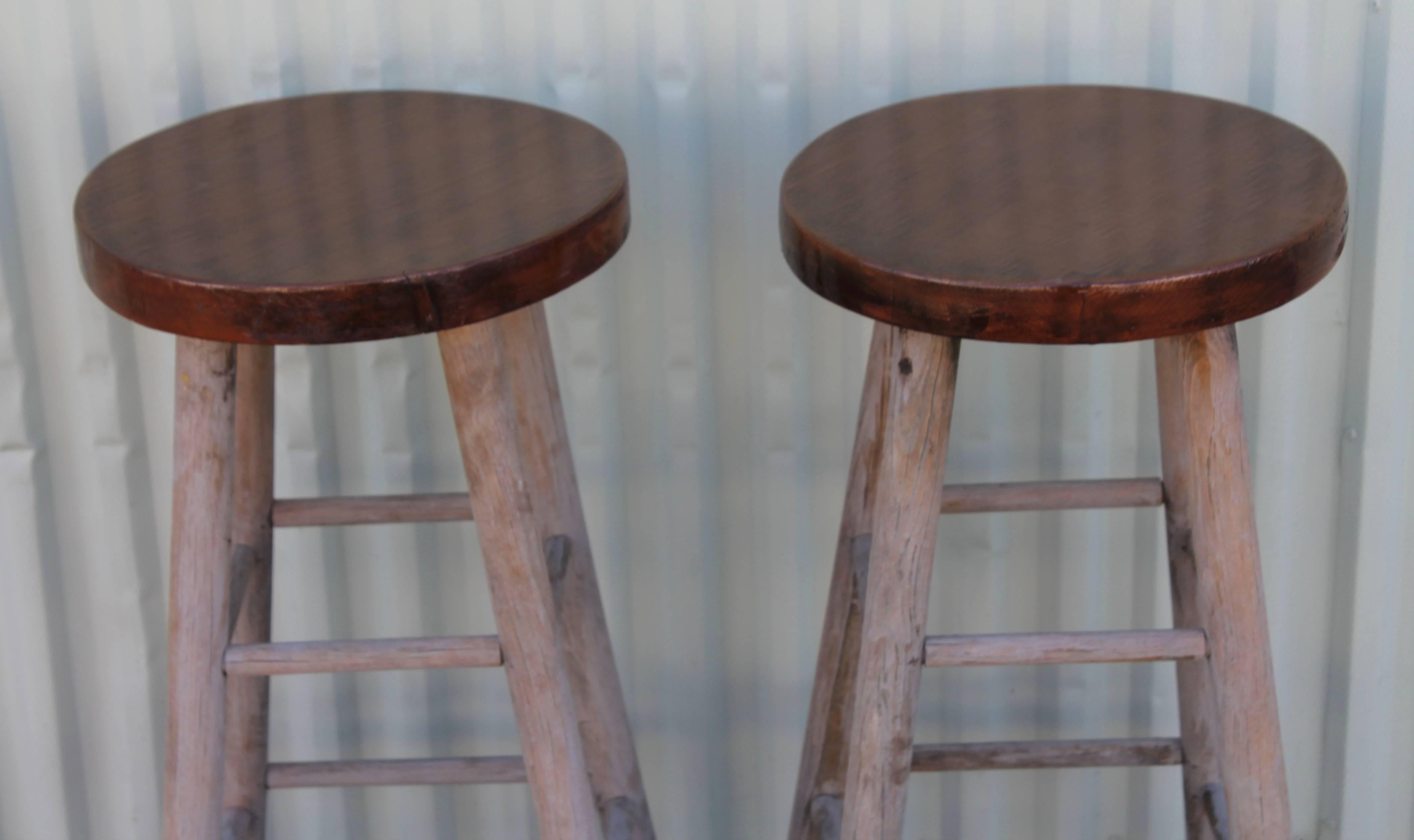 Pair of plank top and very distressed painted bar stools. They are sturdy and in good condition.