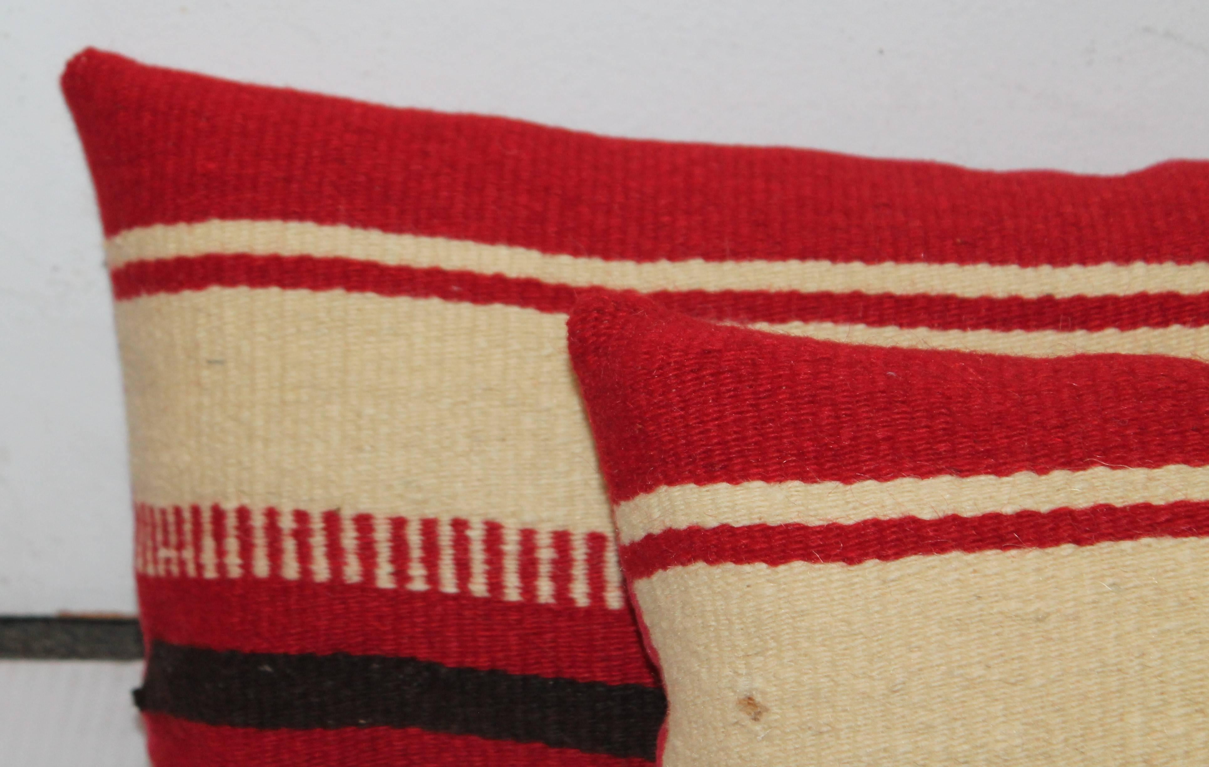 These amazing striped weaving's are from a Mexican saddle blanket and have red cotton linen backings. Sold as a pair.