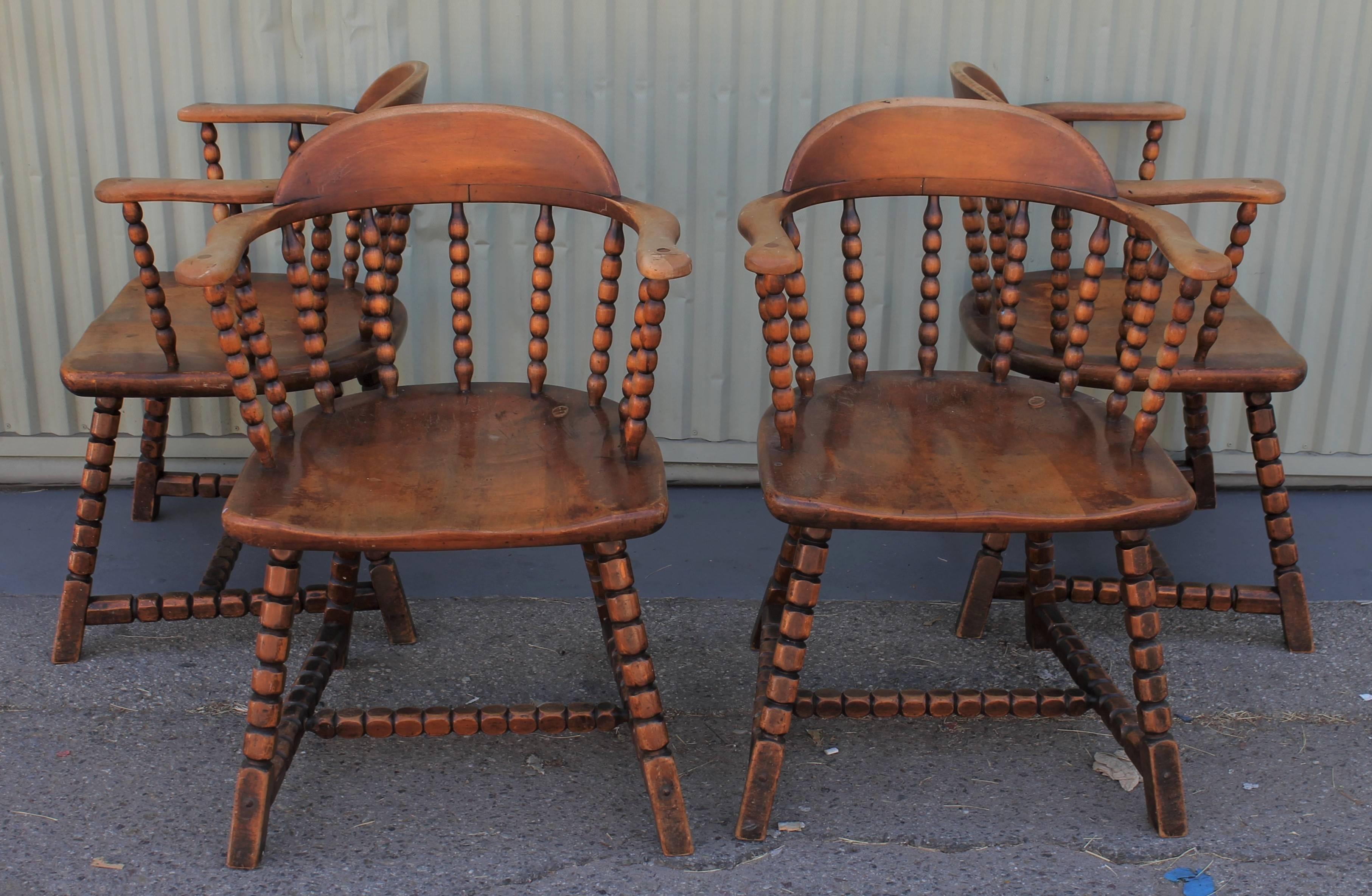 These western Monterey style worn captains chairs have a look of a saloon from the Mid-West. The worn spindle legs have hand-hammered copper nails in them. Seat height is 17