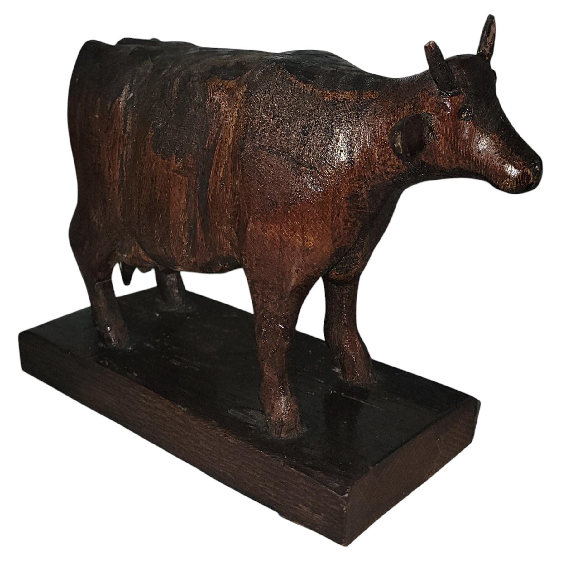 Signed M.O. Thomas Carved Wooden Cow For Sale
