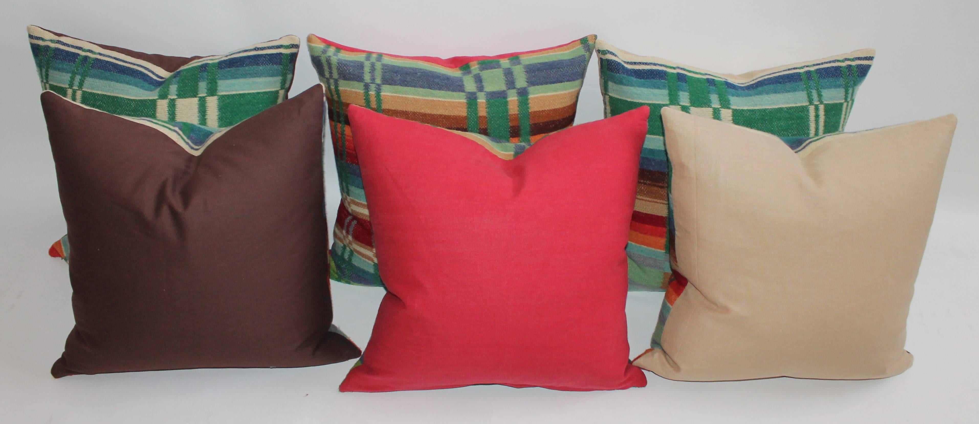 These fantastic 19th century wool horse blanket pillows are sold in pairs and in very good condition. The backings are in red, brown and tan cotton linen. Sold in pairs.