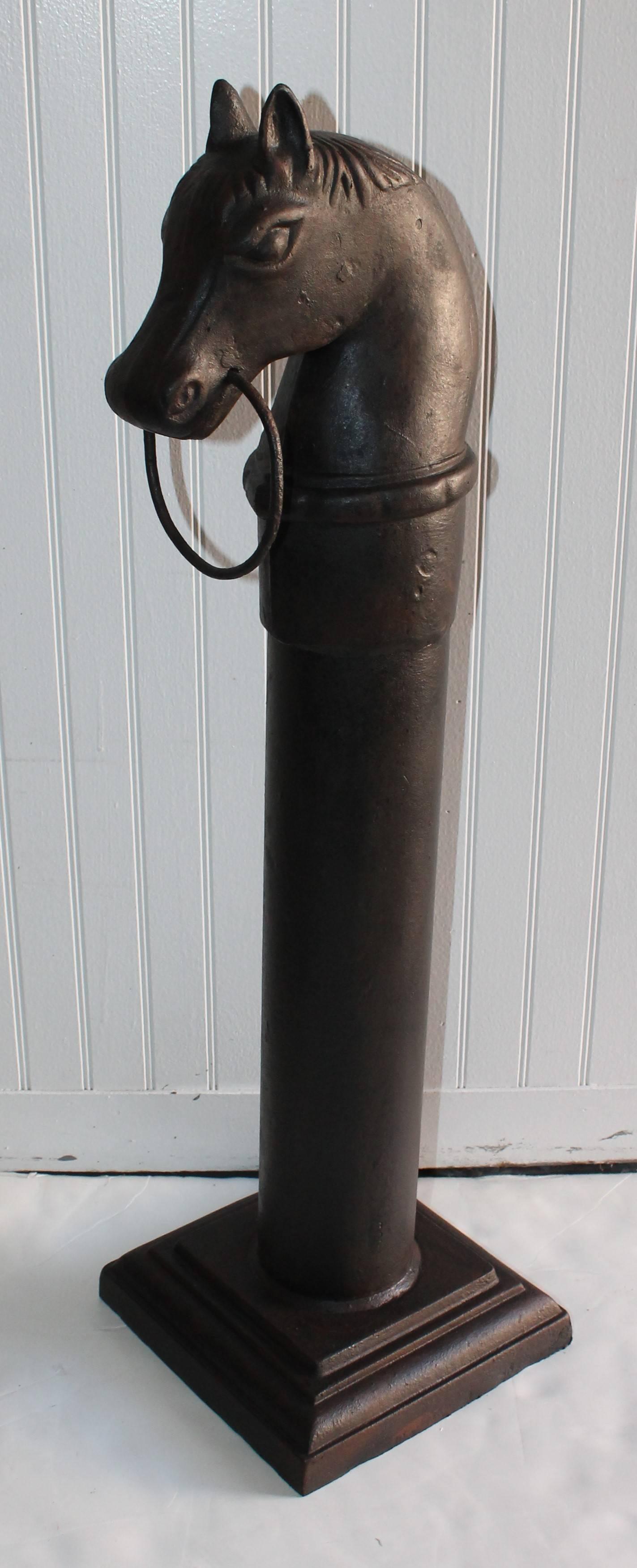 19th century cast iron hitching post in old painted black surface. The condition is very good and sturdy. So unusual to see the hitching post with the original iron base.