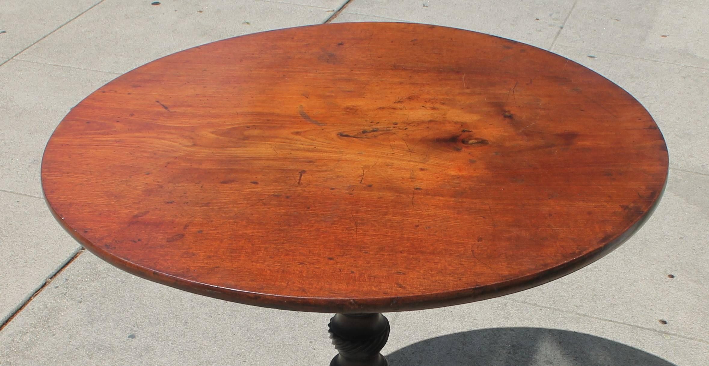 This simple form handmade walnut lift top table is in great condition. Underneath the tabletop has a dovetailed joint box. The pedestal has a old original dark painted and hand-carved snake leg base.